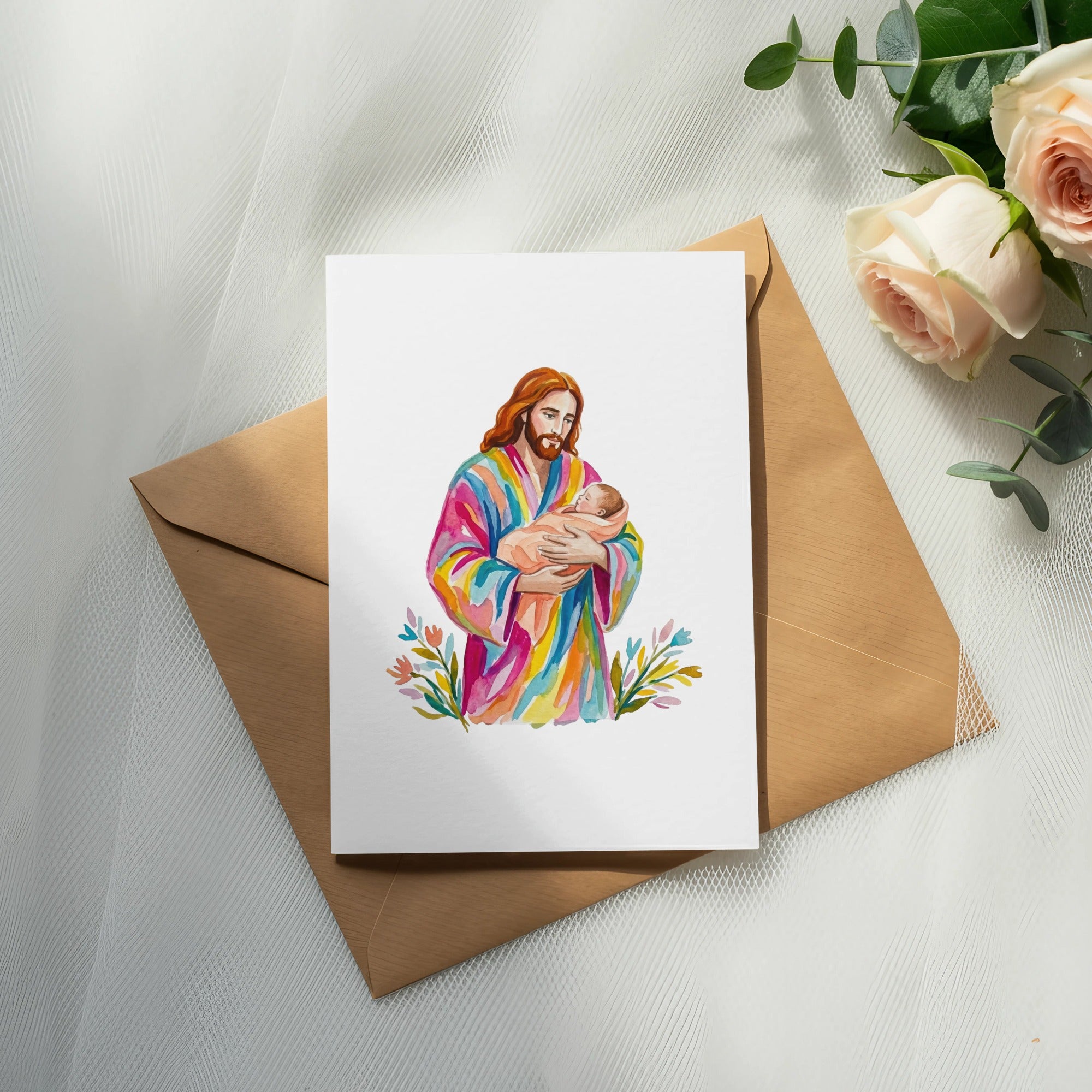 Watercolor painting of Jesus holding a baby, on a card.