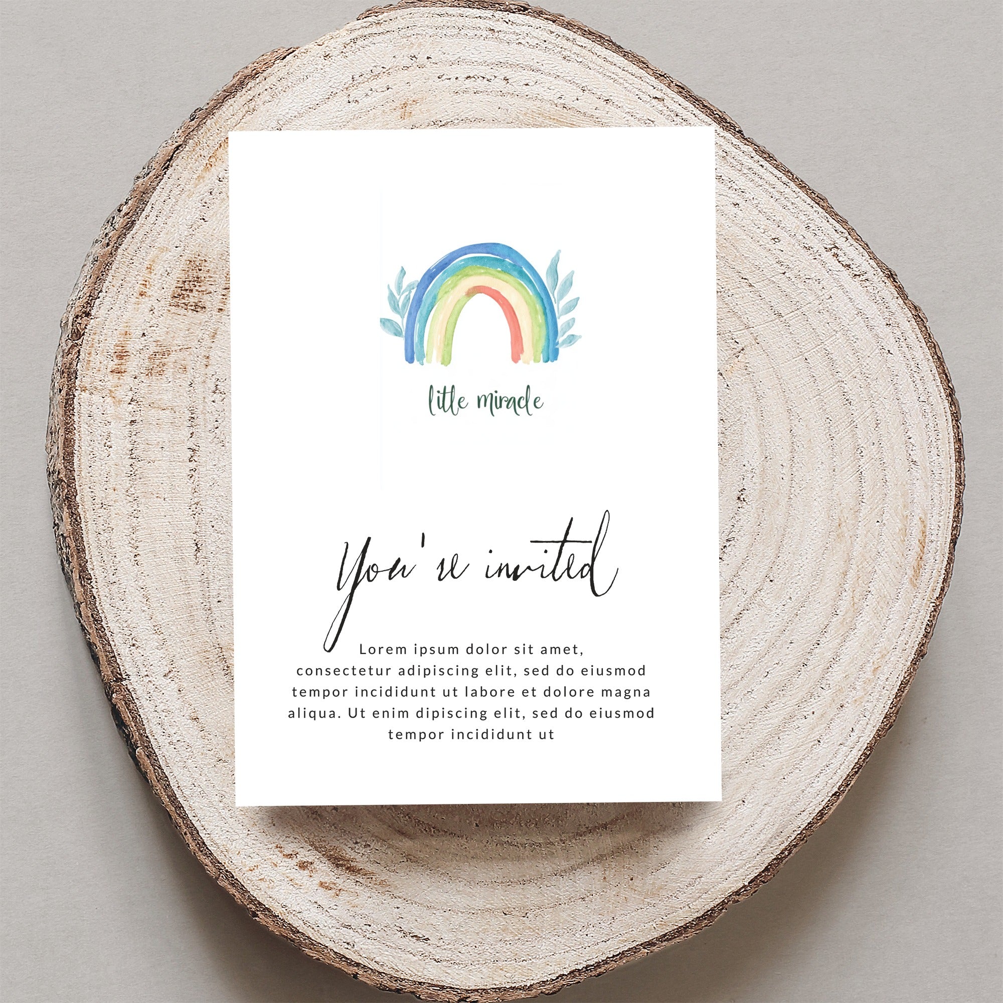 Invitation with "You're invited" and a watercolor rainbow.