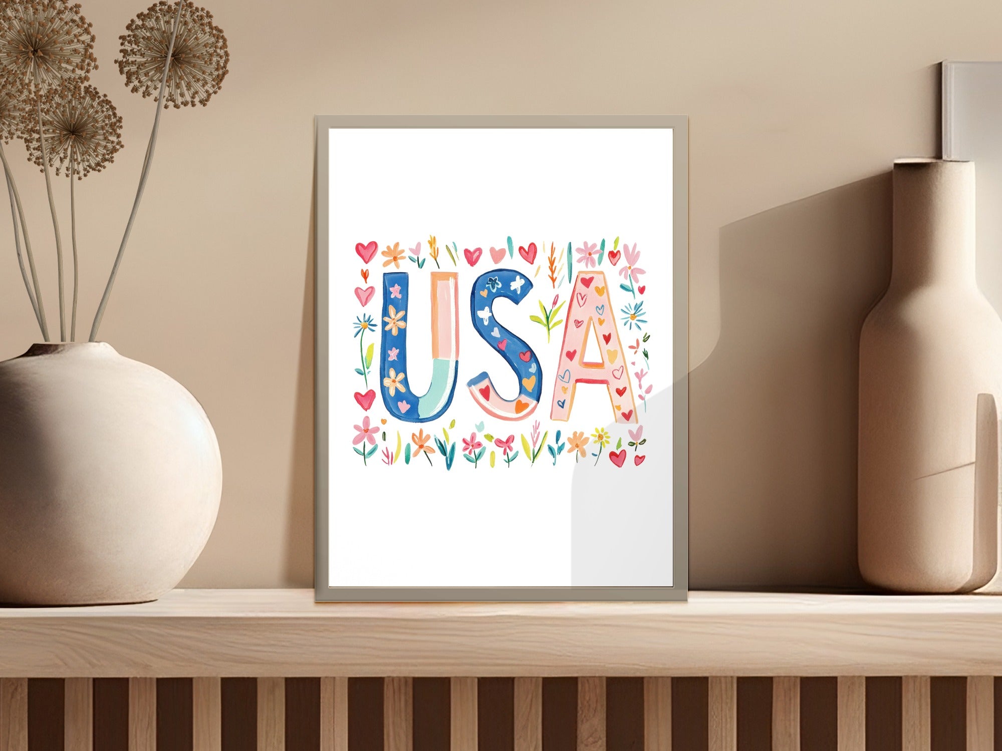 Framed colorful "USA" lettering with floral and heart accents.