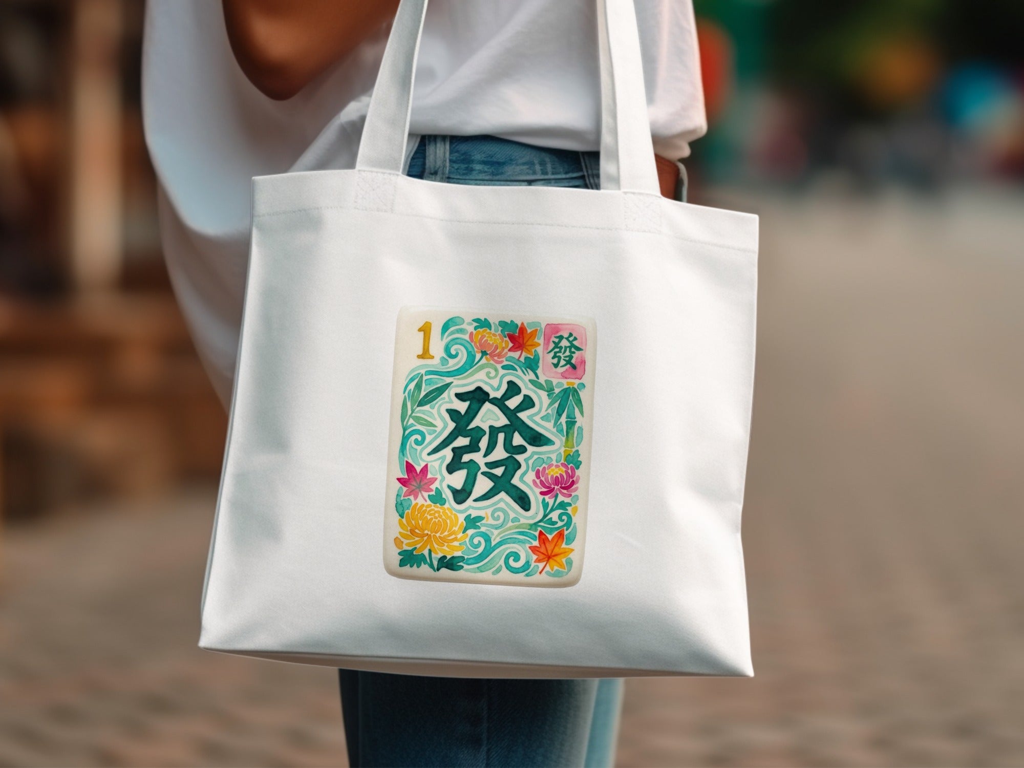 White tote bag with a colorful mahjong tile illustration.
