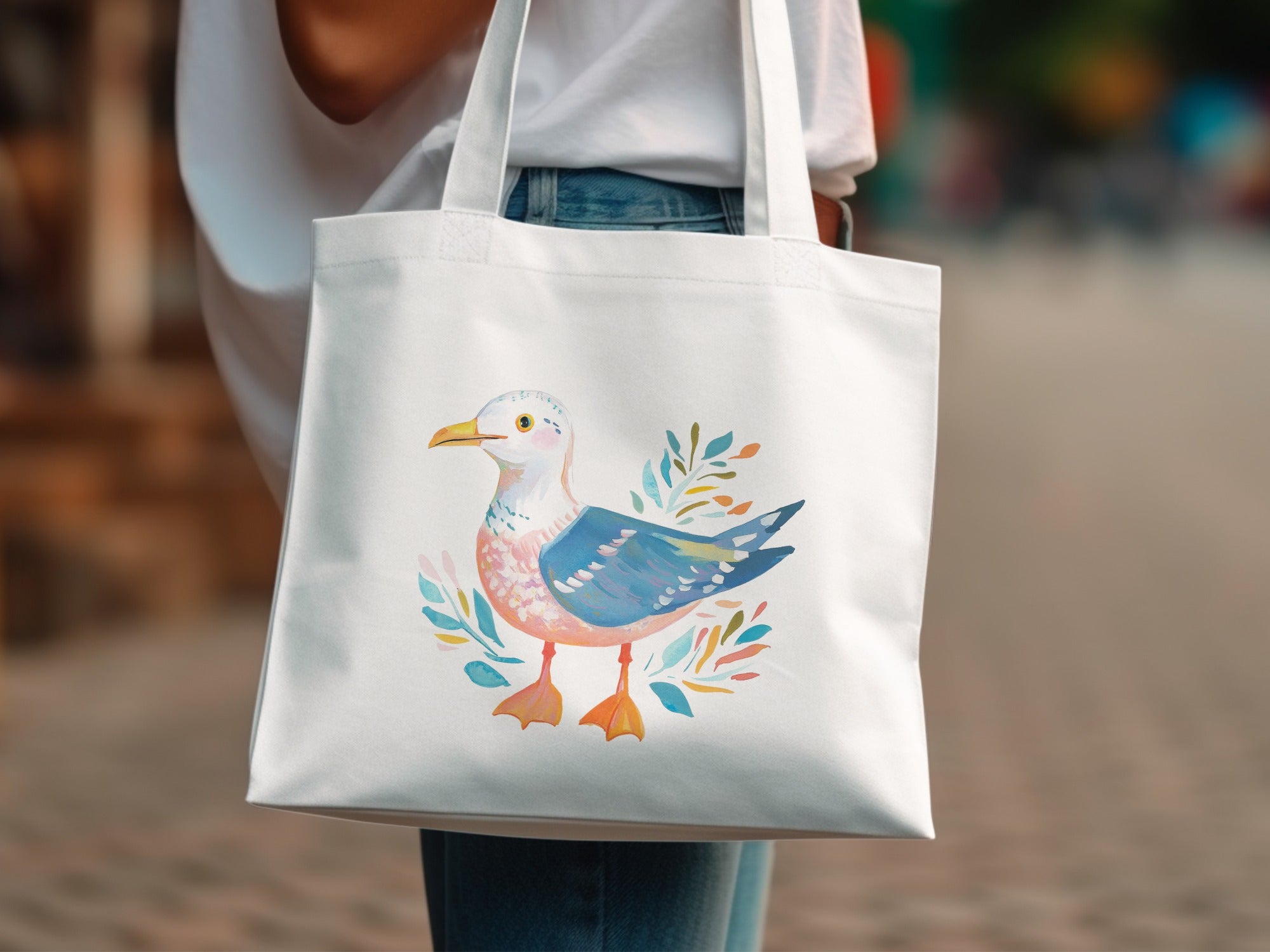 White tote bag with watercolor seagull and leafy branches design.