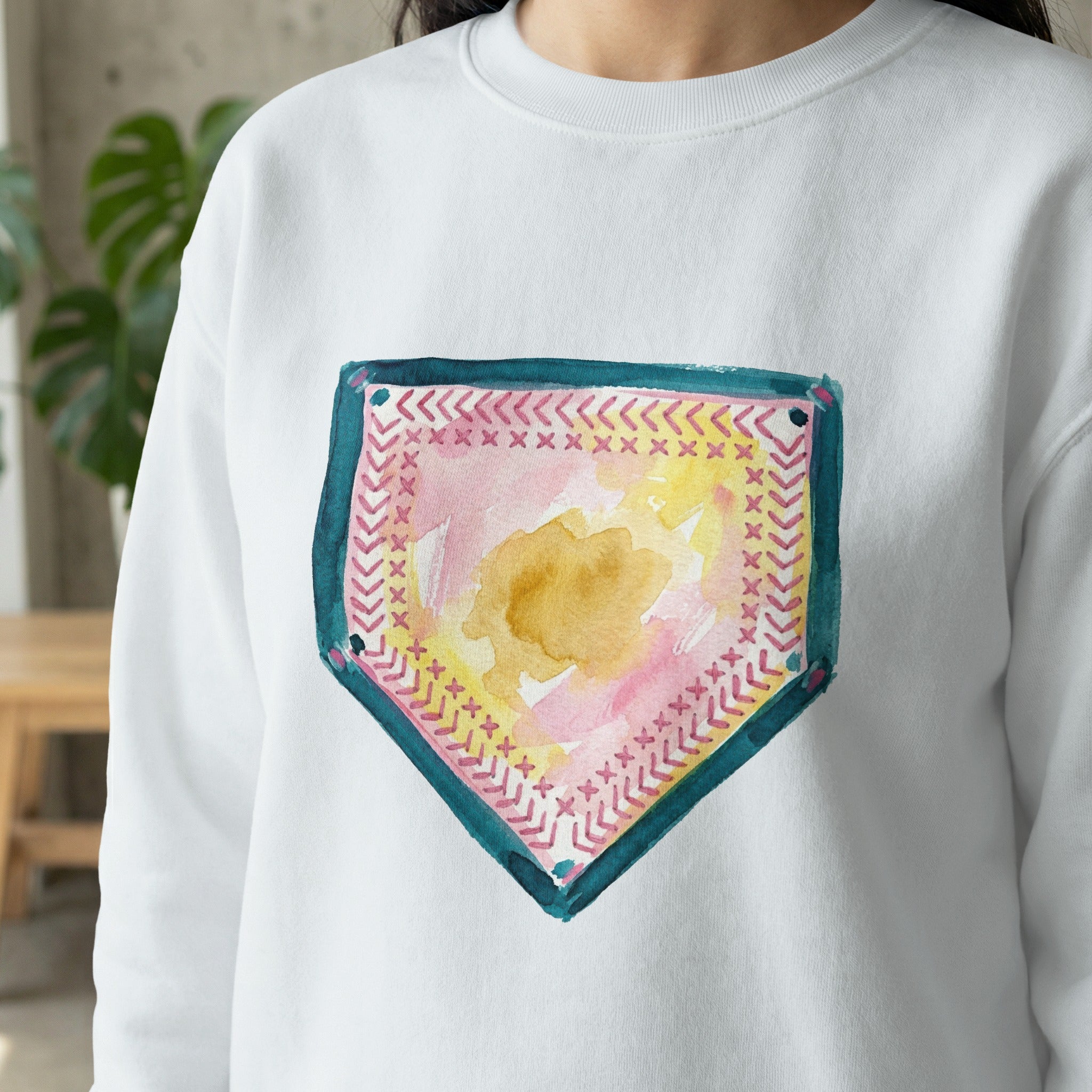 White sweatshirt with a watercolor baseball home plate design.