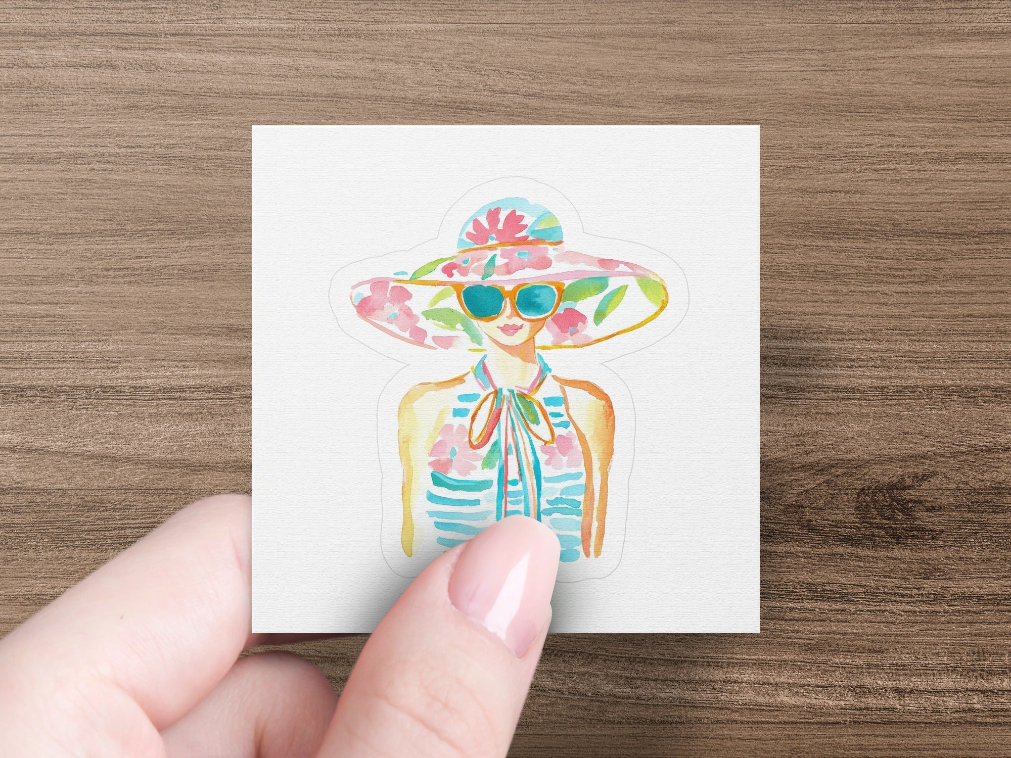 Woman wearing a wide-brimmed floral hat and striped shirt.