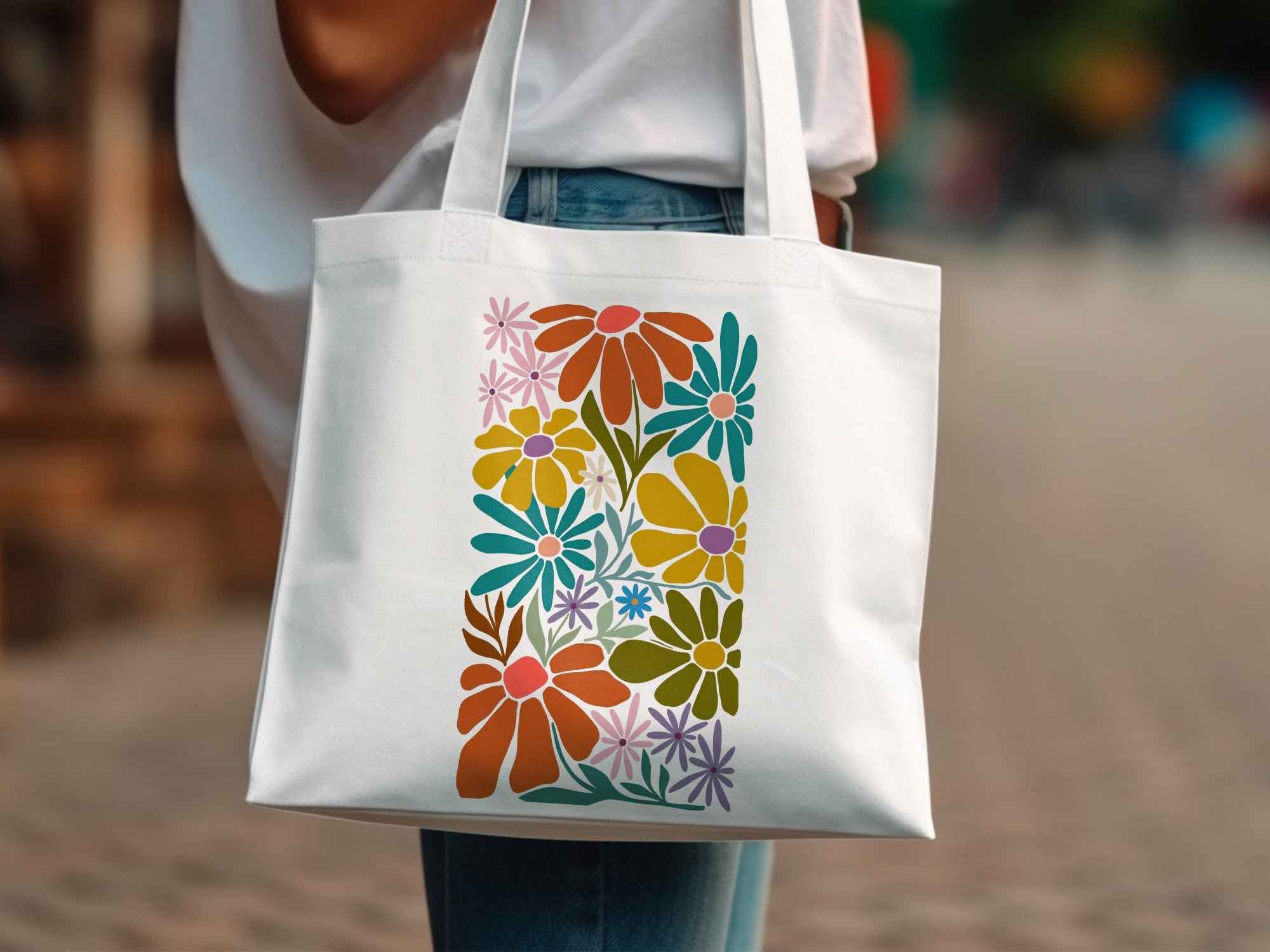 White canvas tote bag with a colorful floral arrangement design.