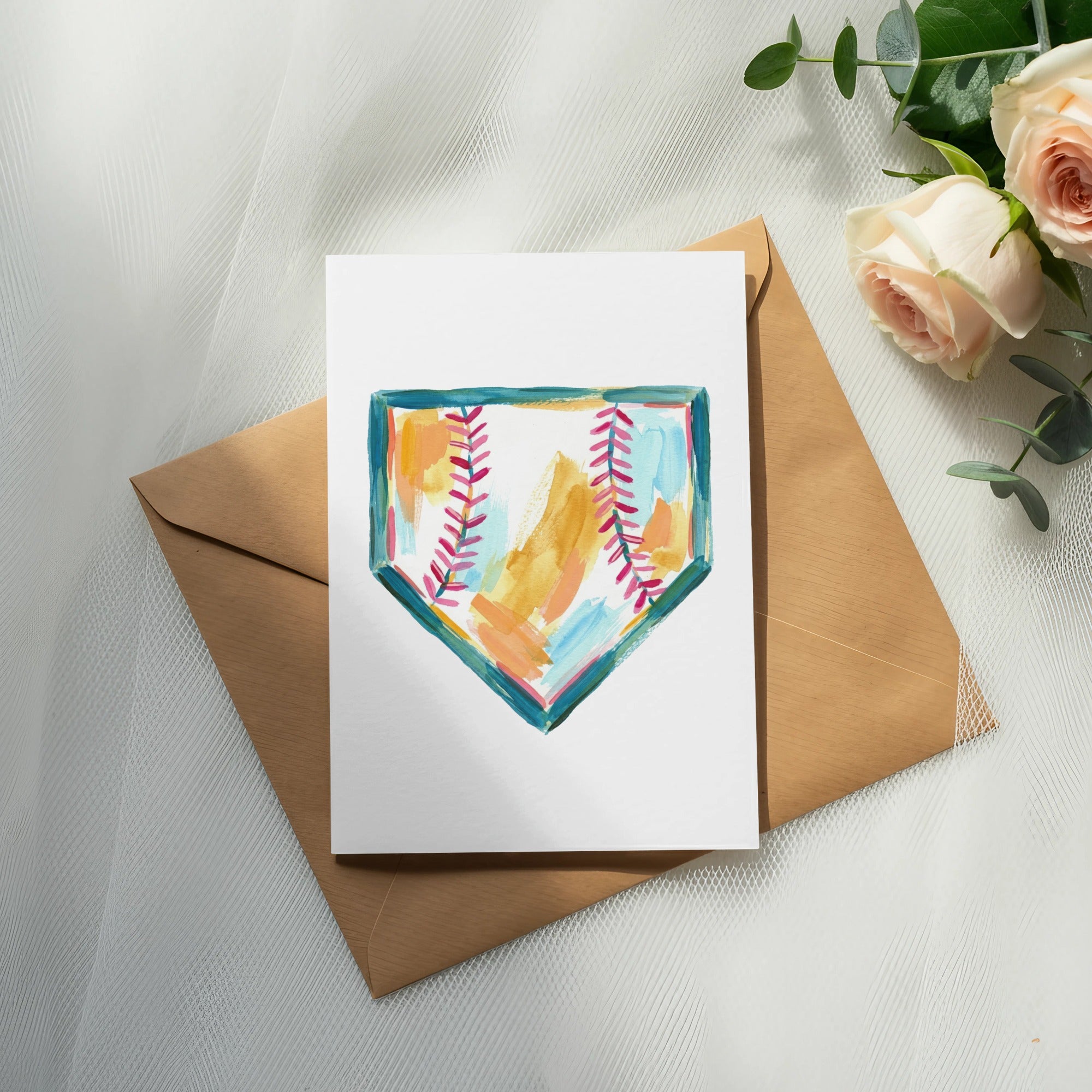 Watercolor baseball home plate illustration on white card over envelope with roses.