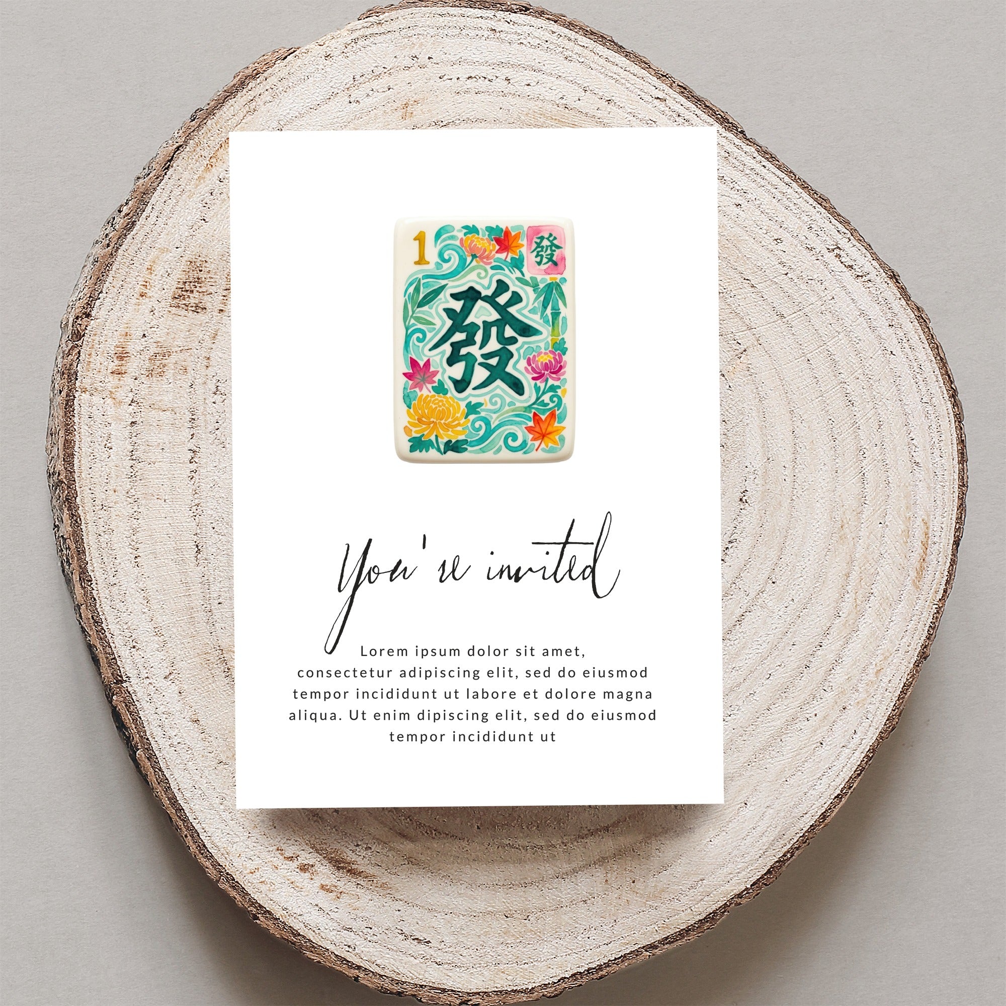 Mahjong tile invitation with floral accents and "You're invited" text.
