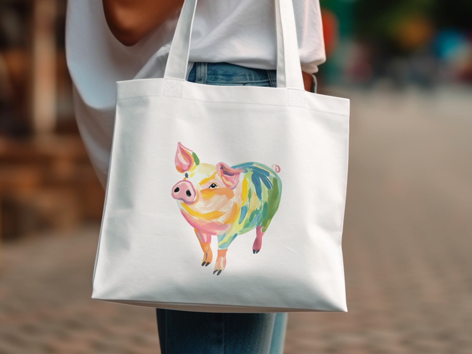 White tote bag featuring a colorful, abstract watercolor pig illustration.