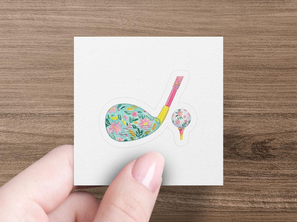 Floral golf club and ball on a tee.