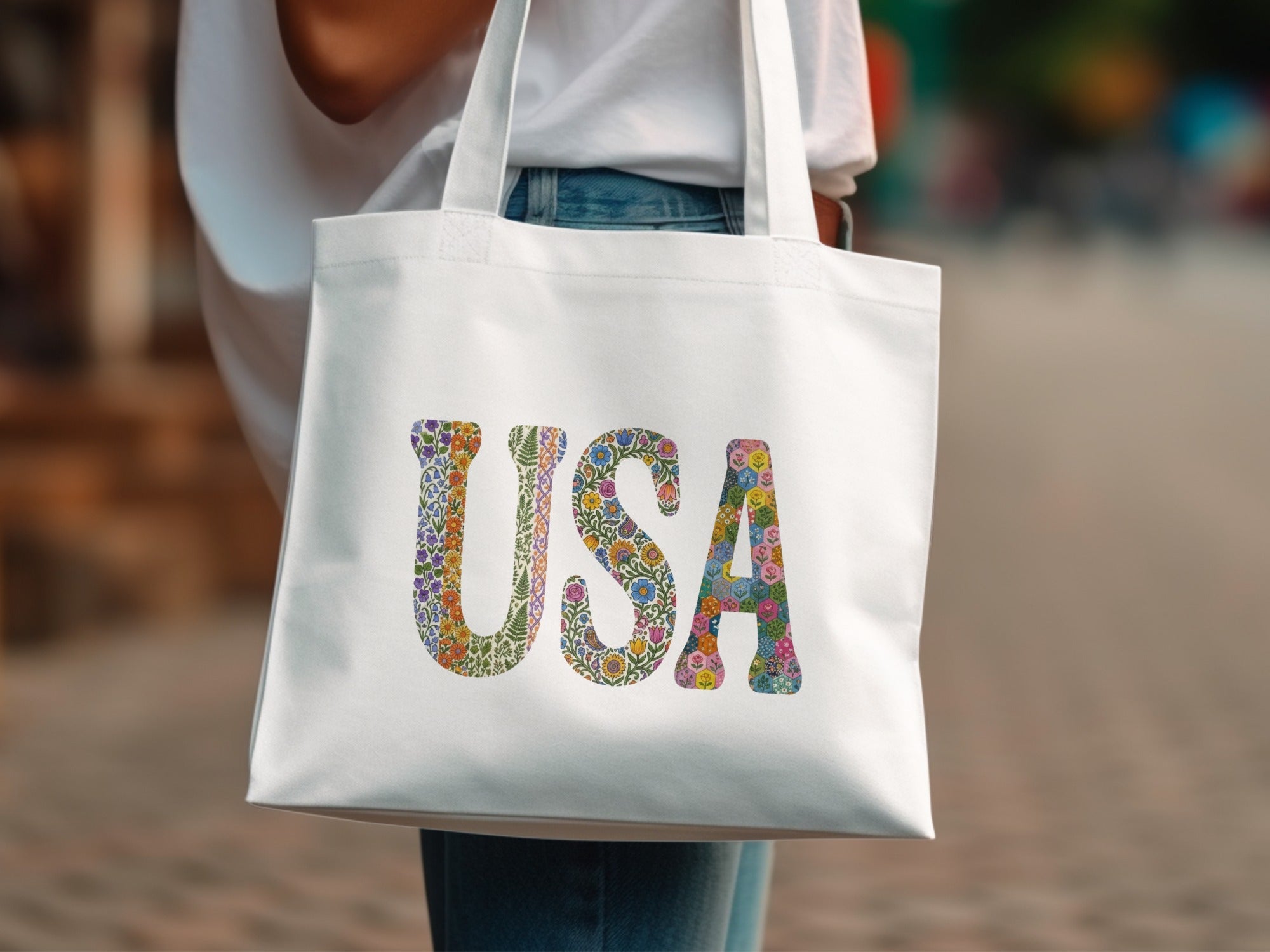 White tote bag with "USA" spelled out in a floral pattern.