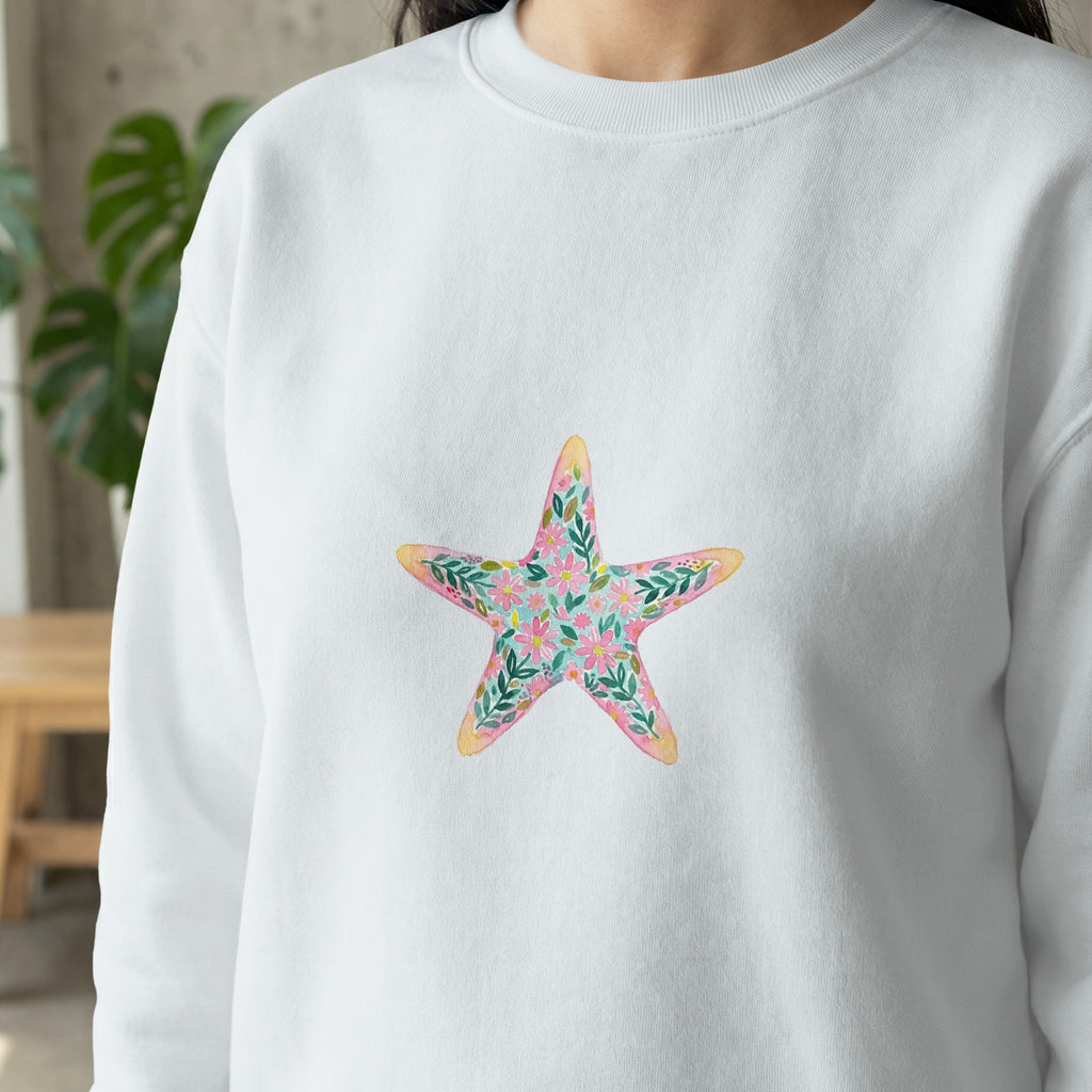 White sweatshirt with a colorful floral starfish graphic.