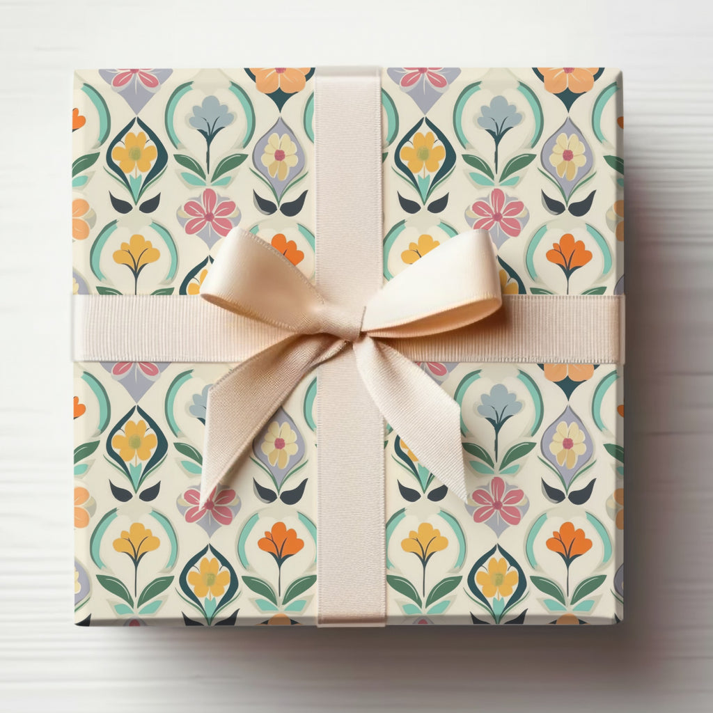 Gift-wrapped box with a floral pattern and a beige ribbon bow.