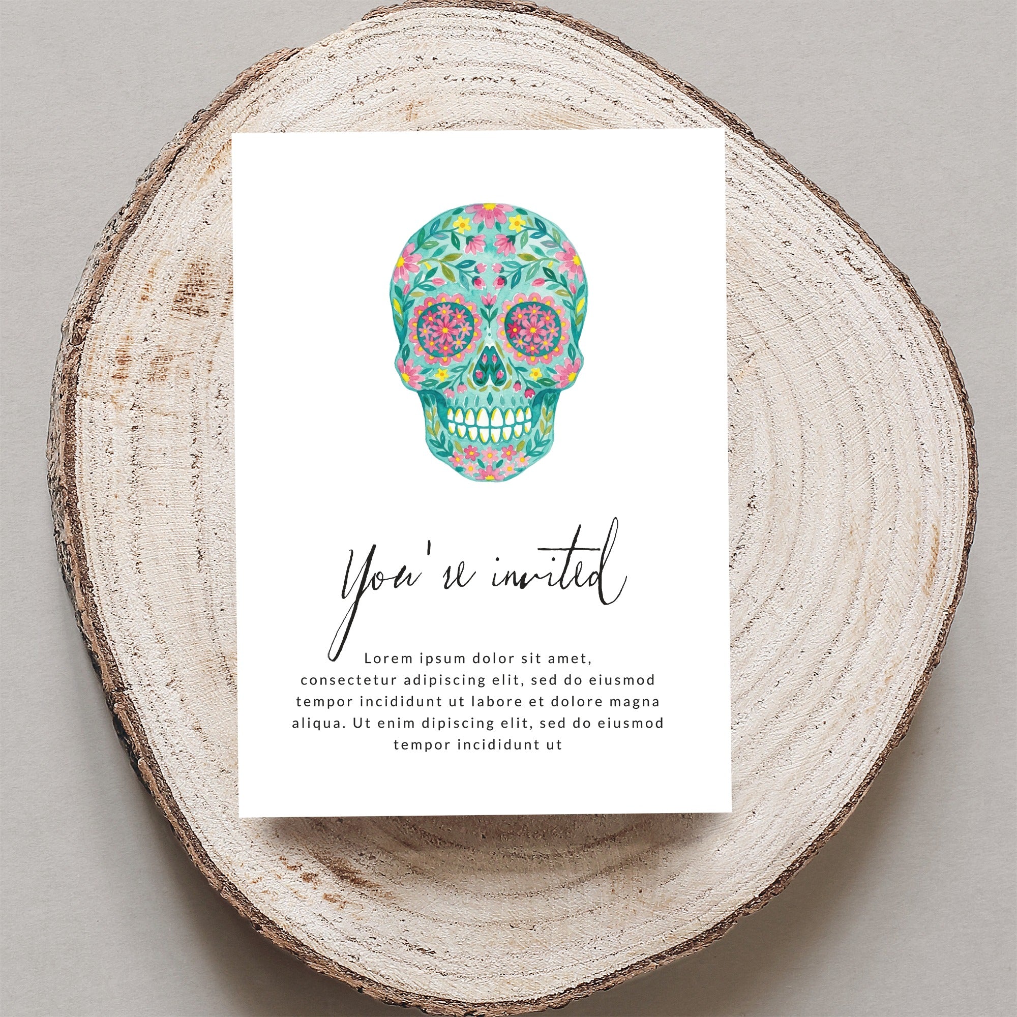 Decorative floral sugar skull invitation with "You're invited" text.