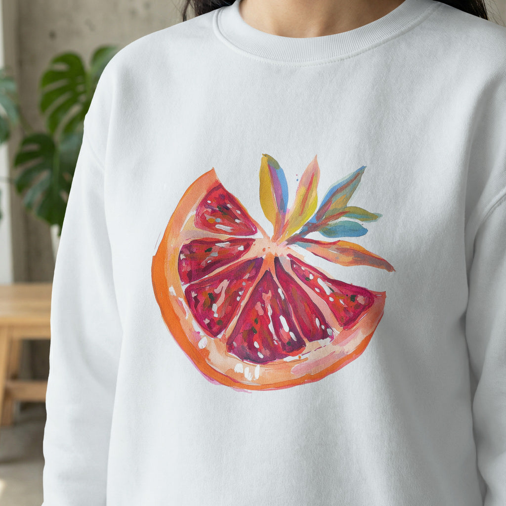 White sweatshirt with a painted grapefruit slice design.