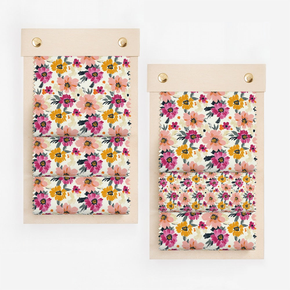 Two fabric swatches with floral patterns of pink, yellow, and orange flowers.