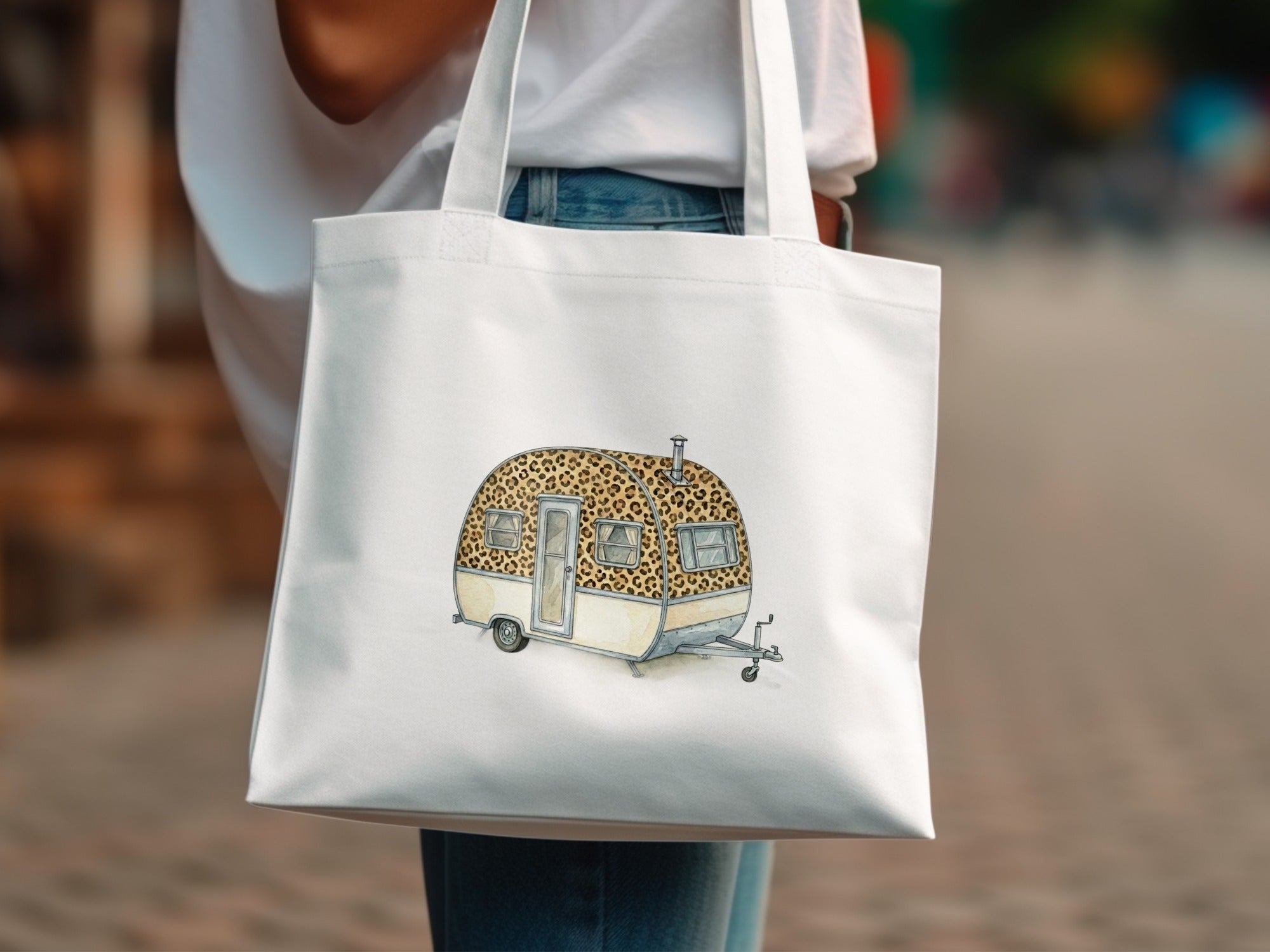 White tote bag with leopard print caravan illustration.