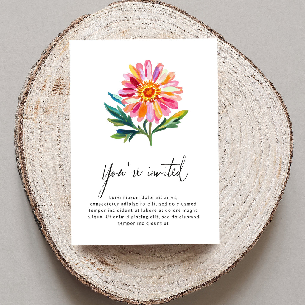 Card with floral illustration and "You're invited" text on wood slice.