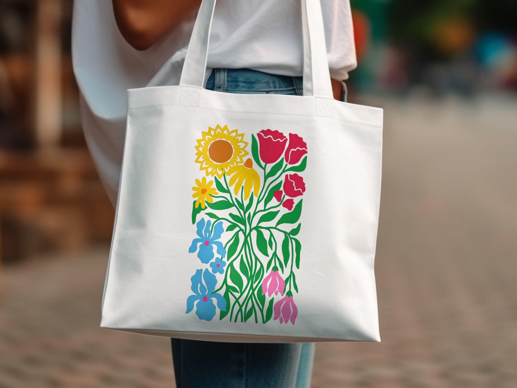 White tote bag with colorful floral and sun graphic.