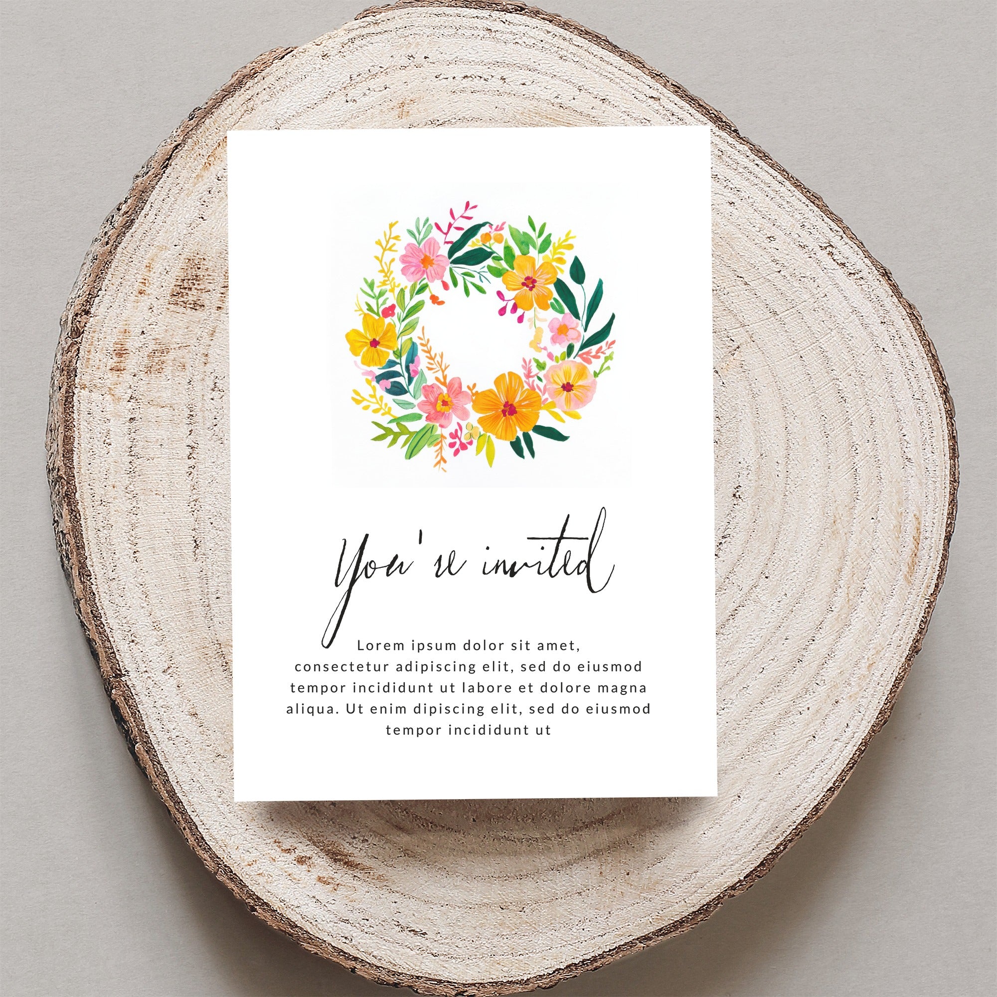 Invitation with floral wreath and "You're invited" text.