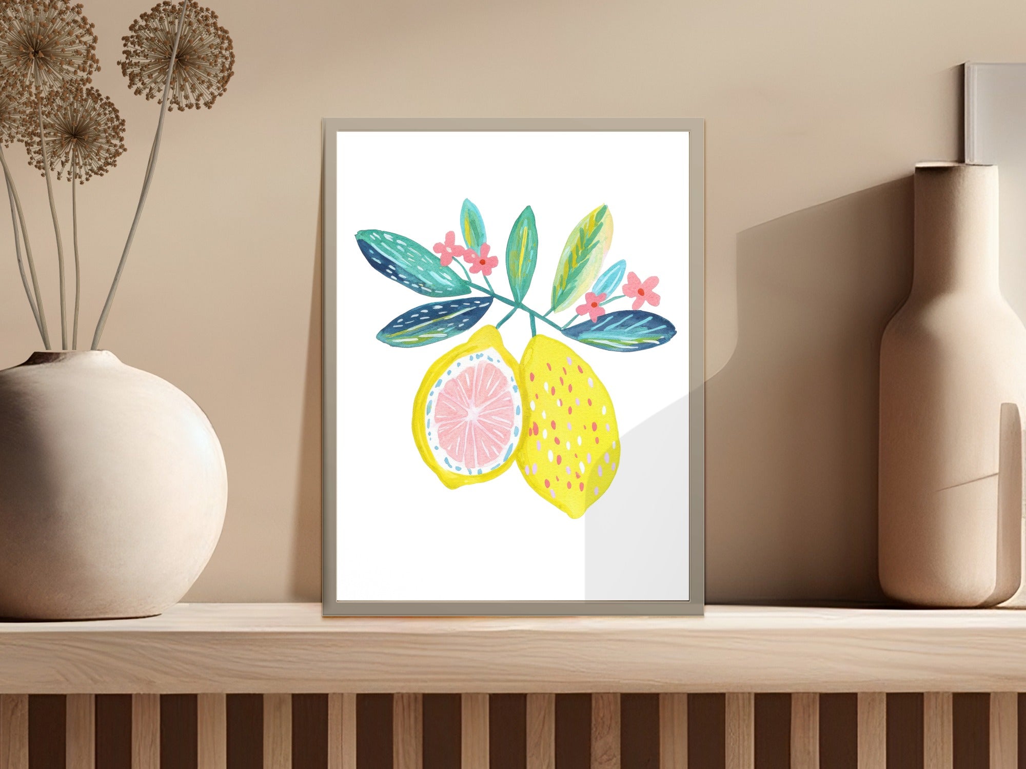 Watercolor painting of lemons with leaves and flowers in a framed print.