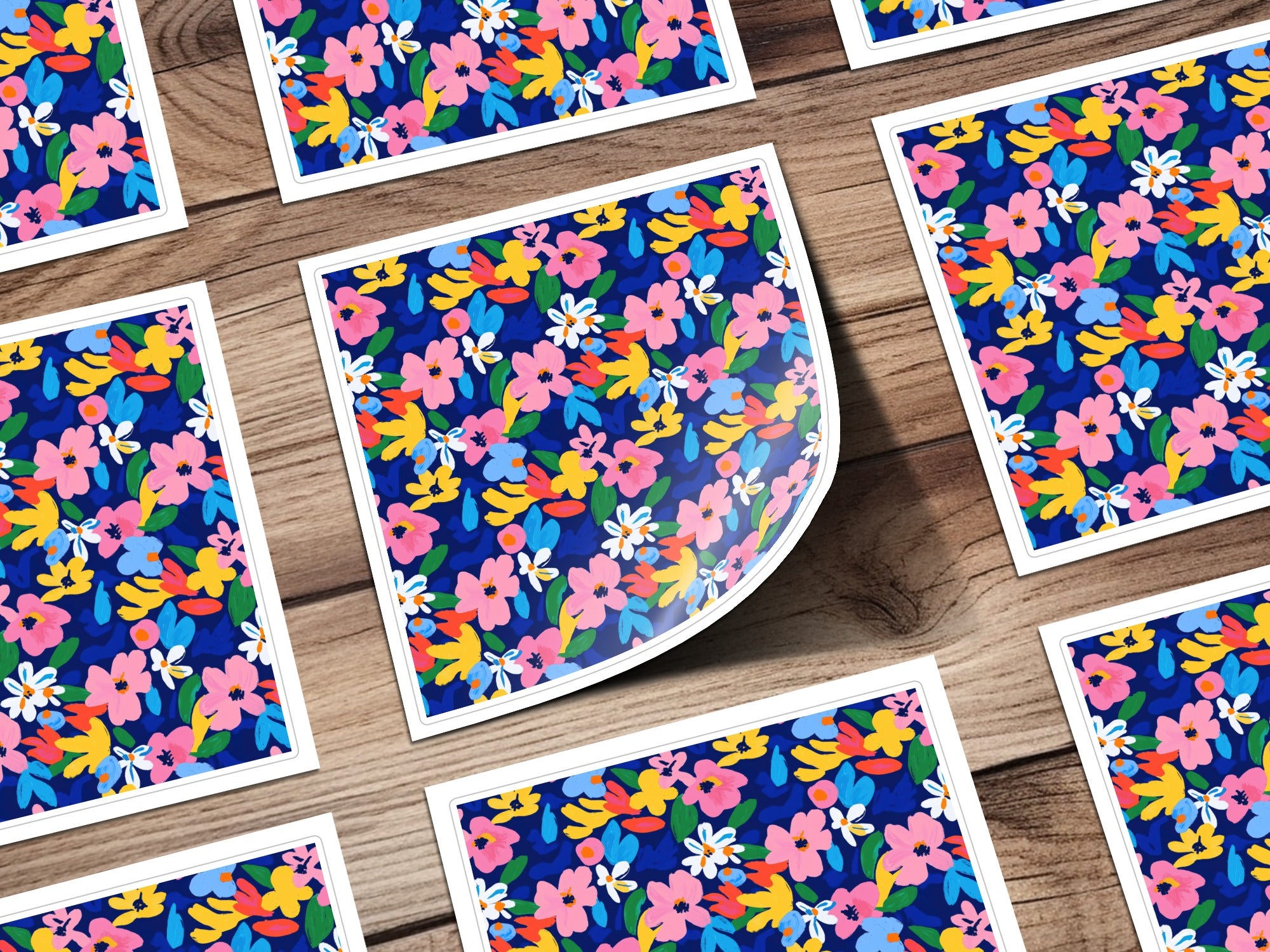 Scattered floral pattern cards on a wooden background.