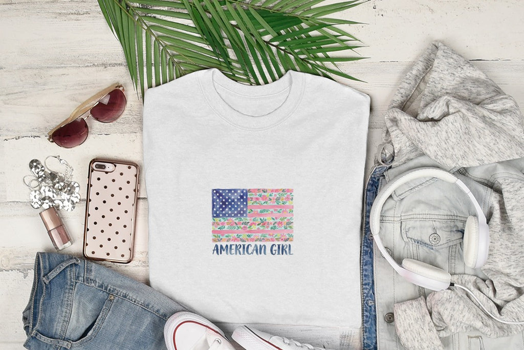 White t-shirt with a watercolor American flag design featuring flowers.
