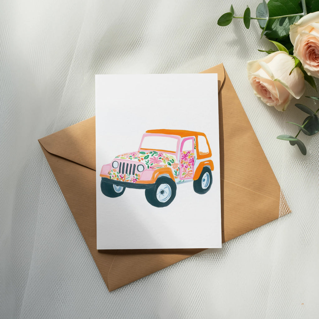 Illustration of a colorful floral jeep on a card atop a brown envelope.