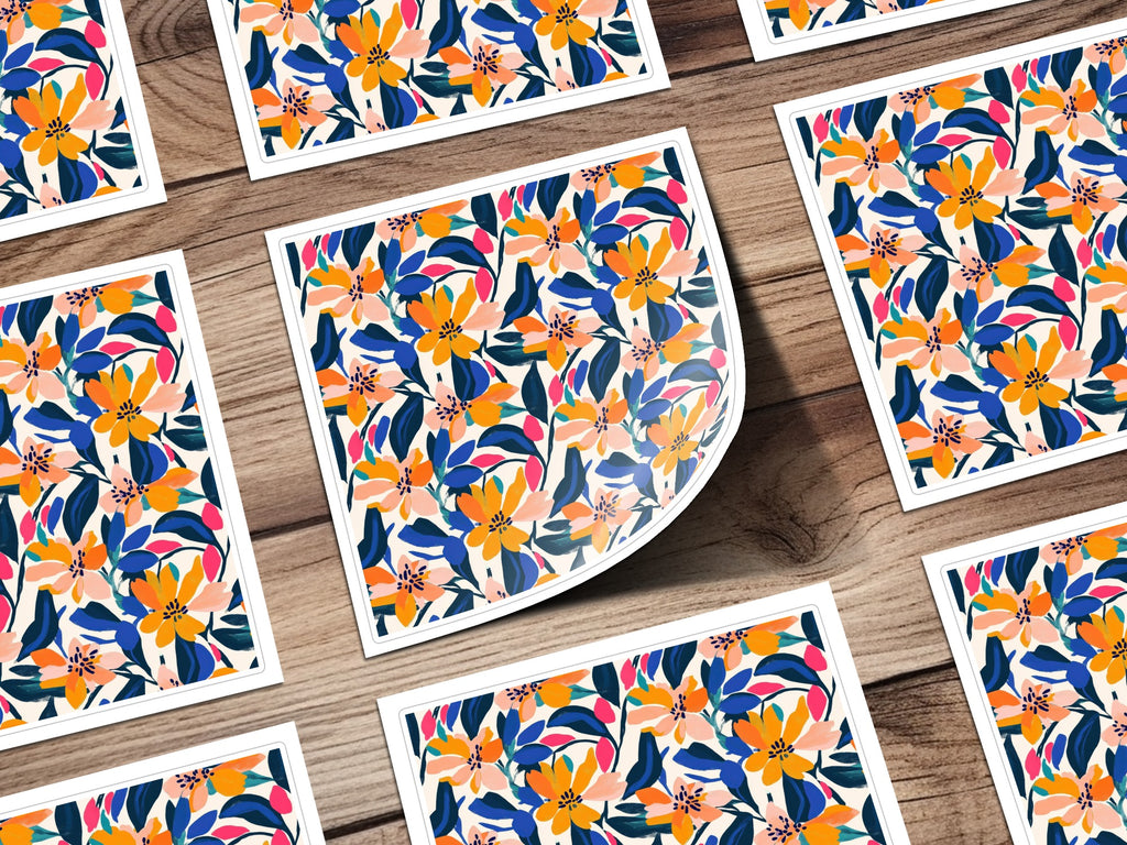 Pattern of colorful abstract flowers and leaves on white cards arranged on a wooden surface.
