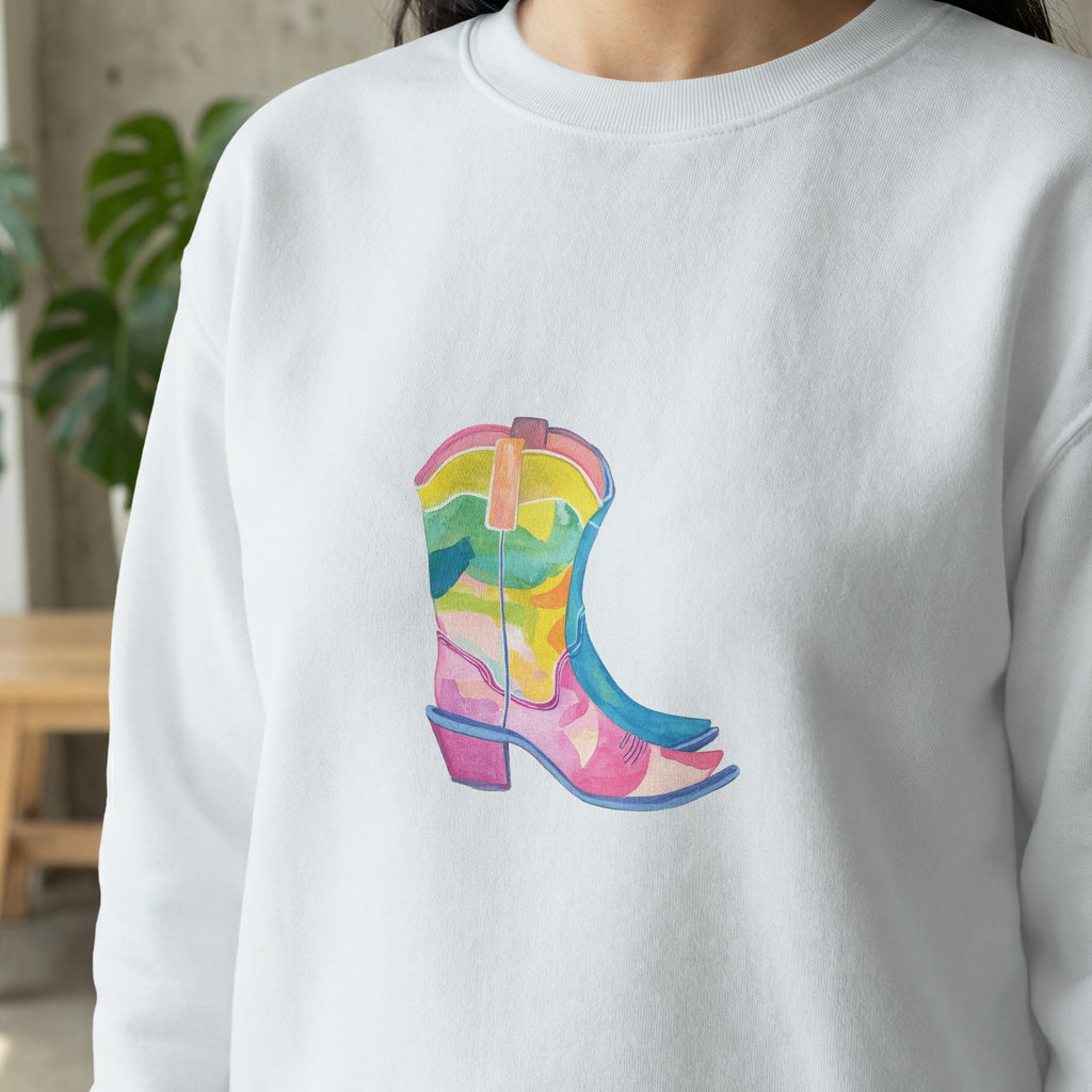 White sweatshirt with a colorful watercolor cowboy boot graphic.
