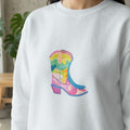White sweatshirt with a colorful watercolor cowboy boot graphic.