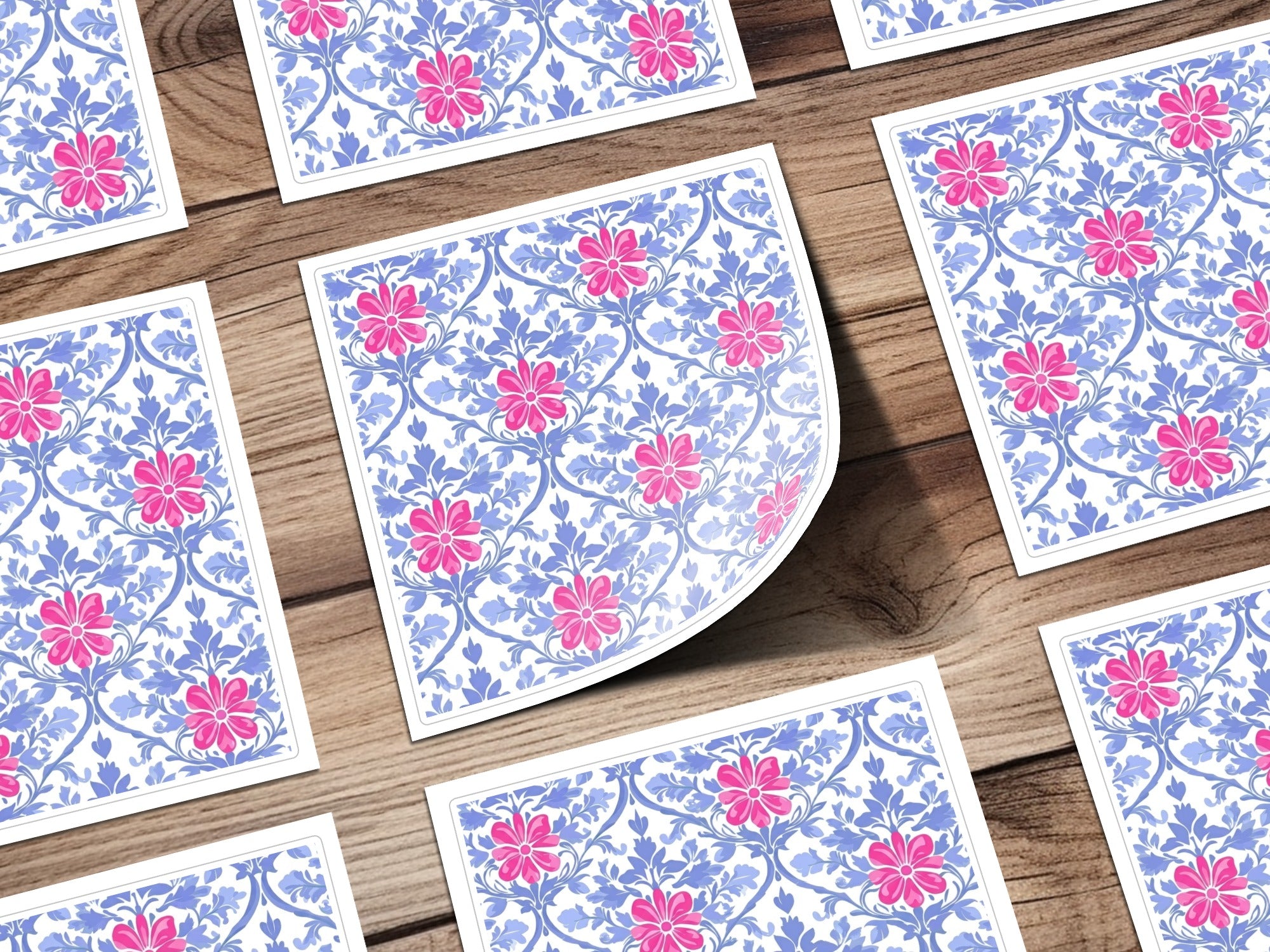 Floral pattern with pink flowers and blue leaves on white cards.