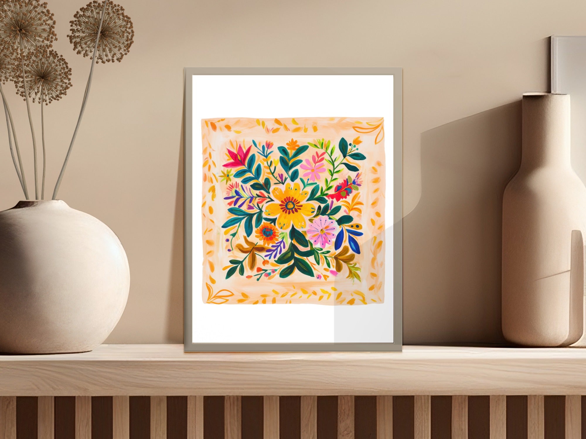 Framed floral embroidery art with colorful blooms and leaves on a light orange background.