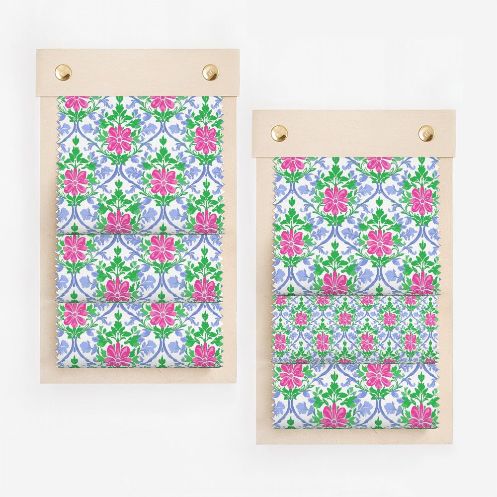 Two fabric swatches with a repeating floral pattern of pink and blue flowers.
