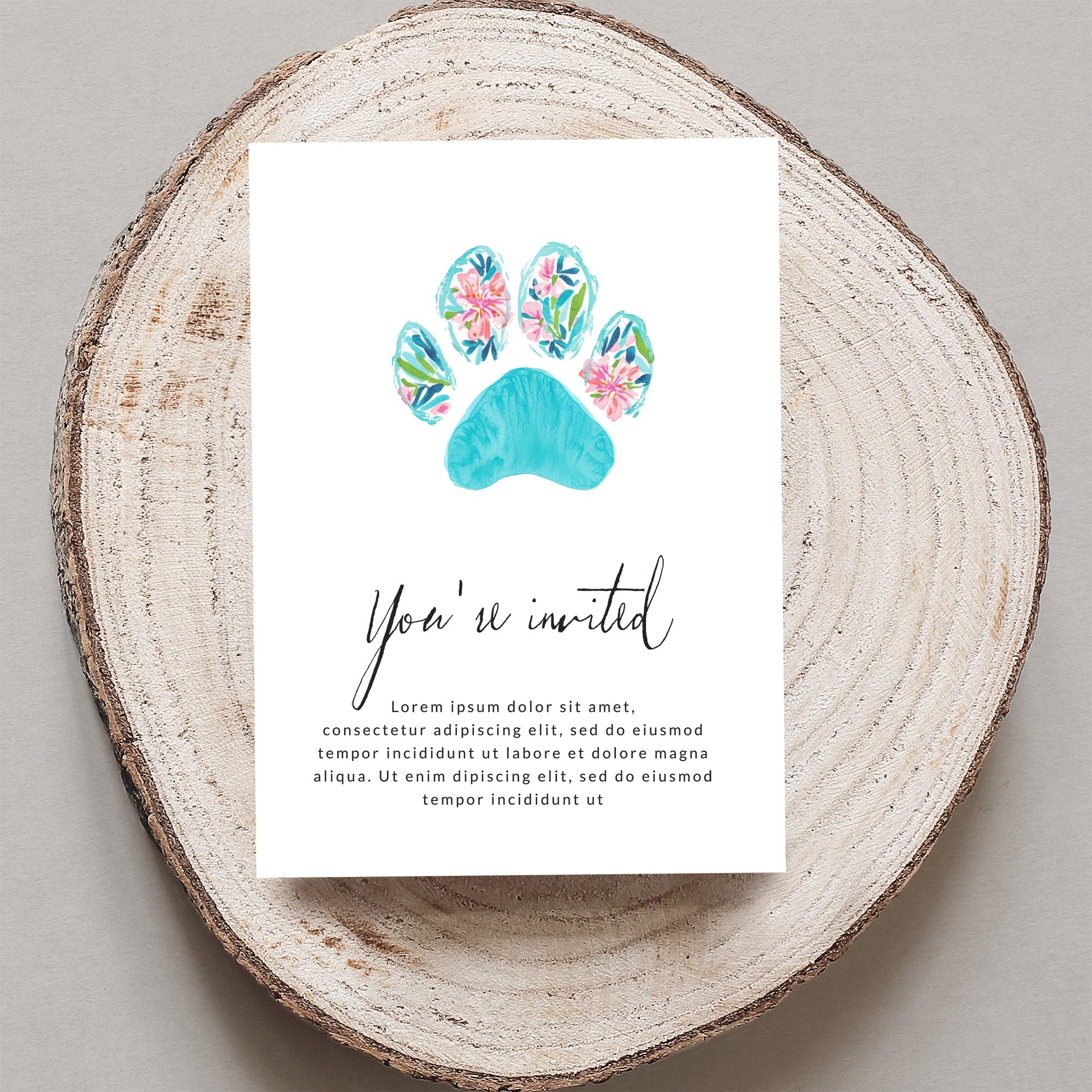 Invitation with floral paw print and "You're invited" text.