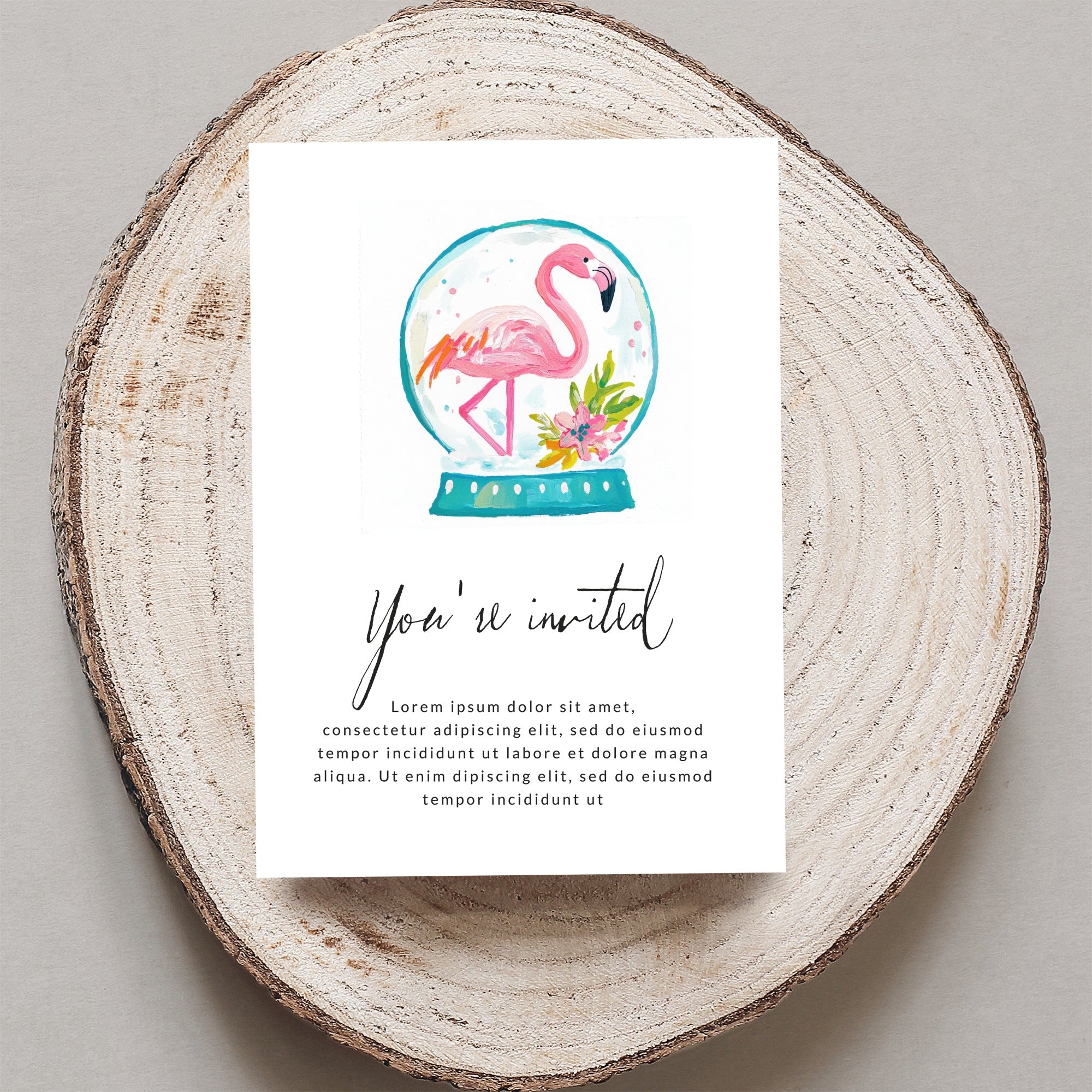 Invitation with flamingo in a snow globe and placeholder text.