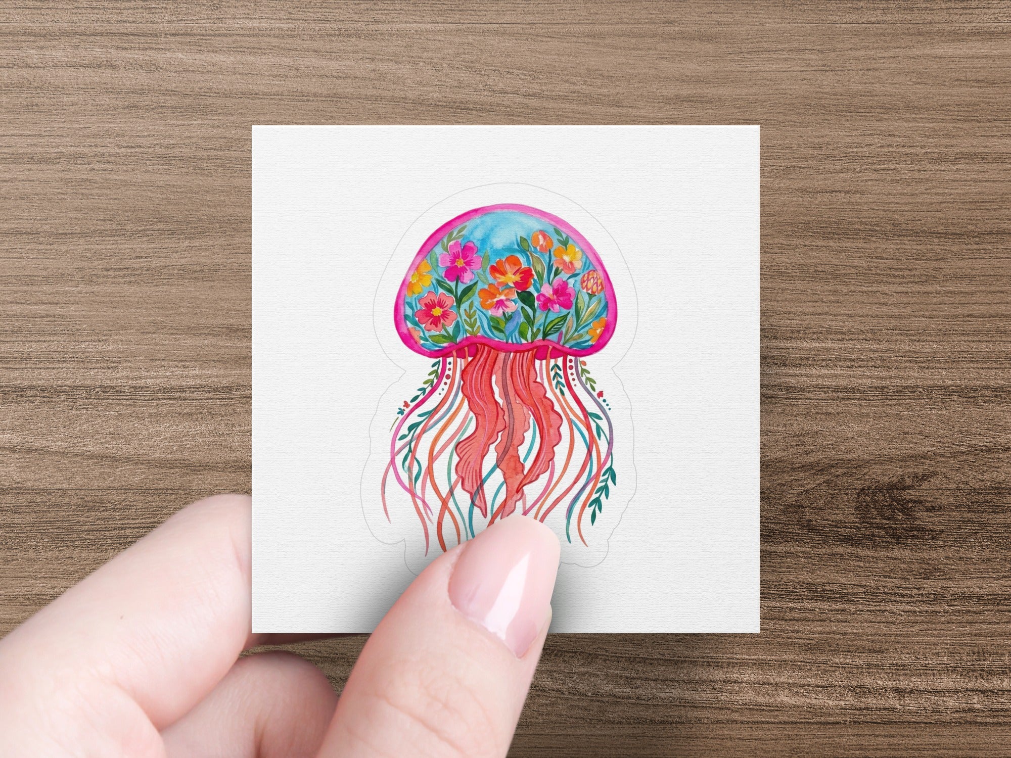 Colorful floral jellyfish sticker with pink tentacles.
