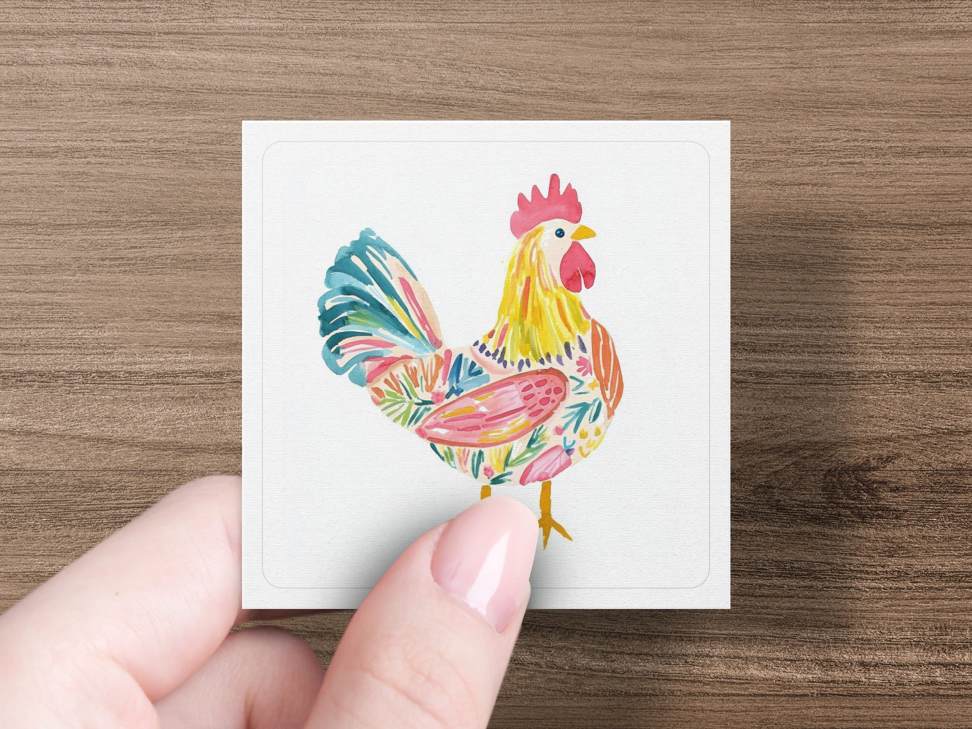Watercolor rooster illustration with floral accents on a white card.
