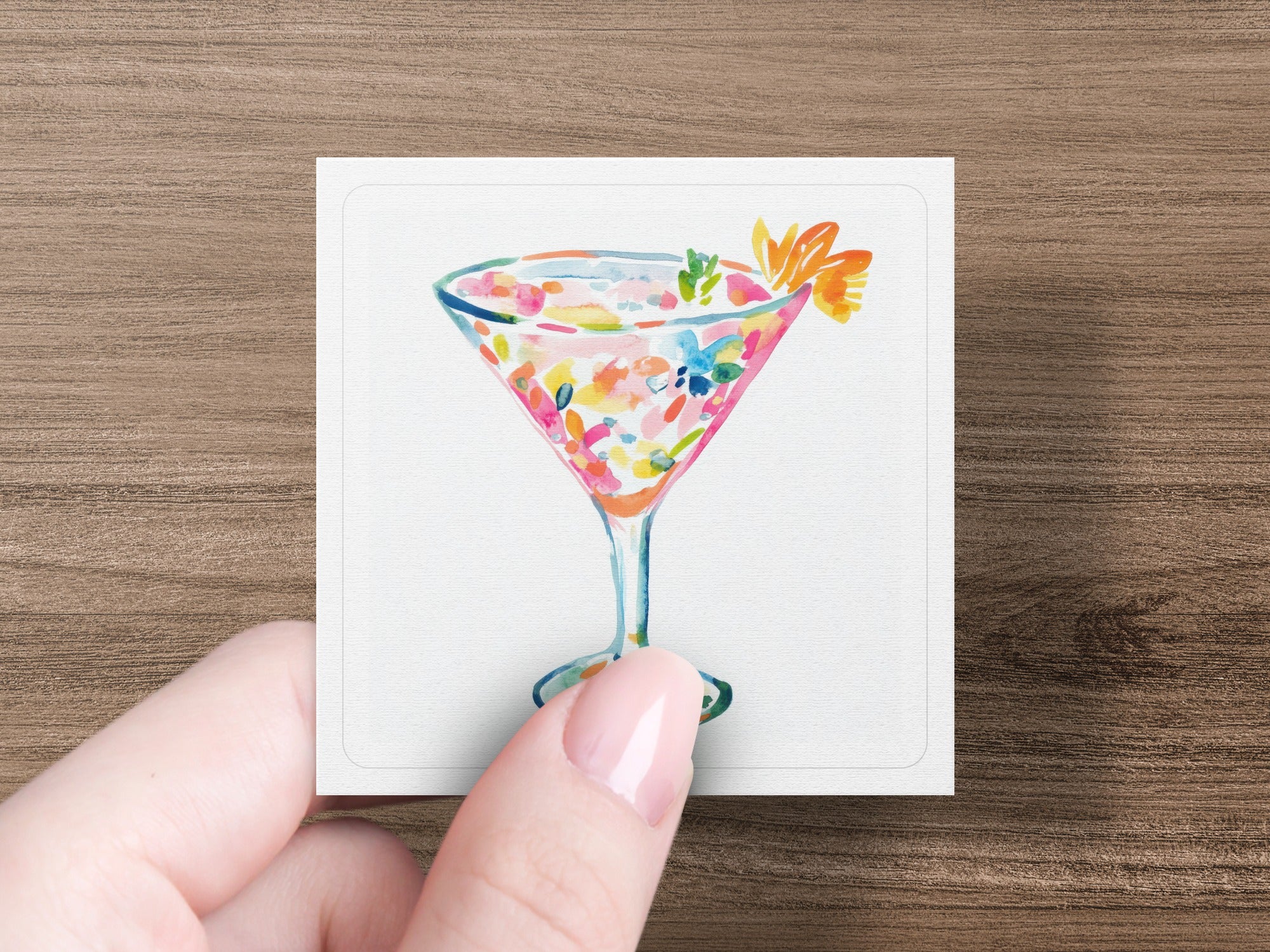 Watercolor illustration of a cocktail with fruit garnishes in a stemmed glass.