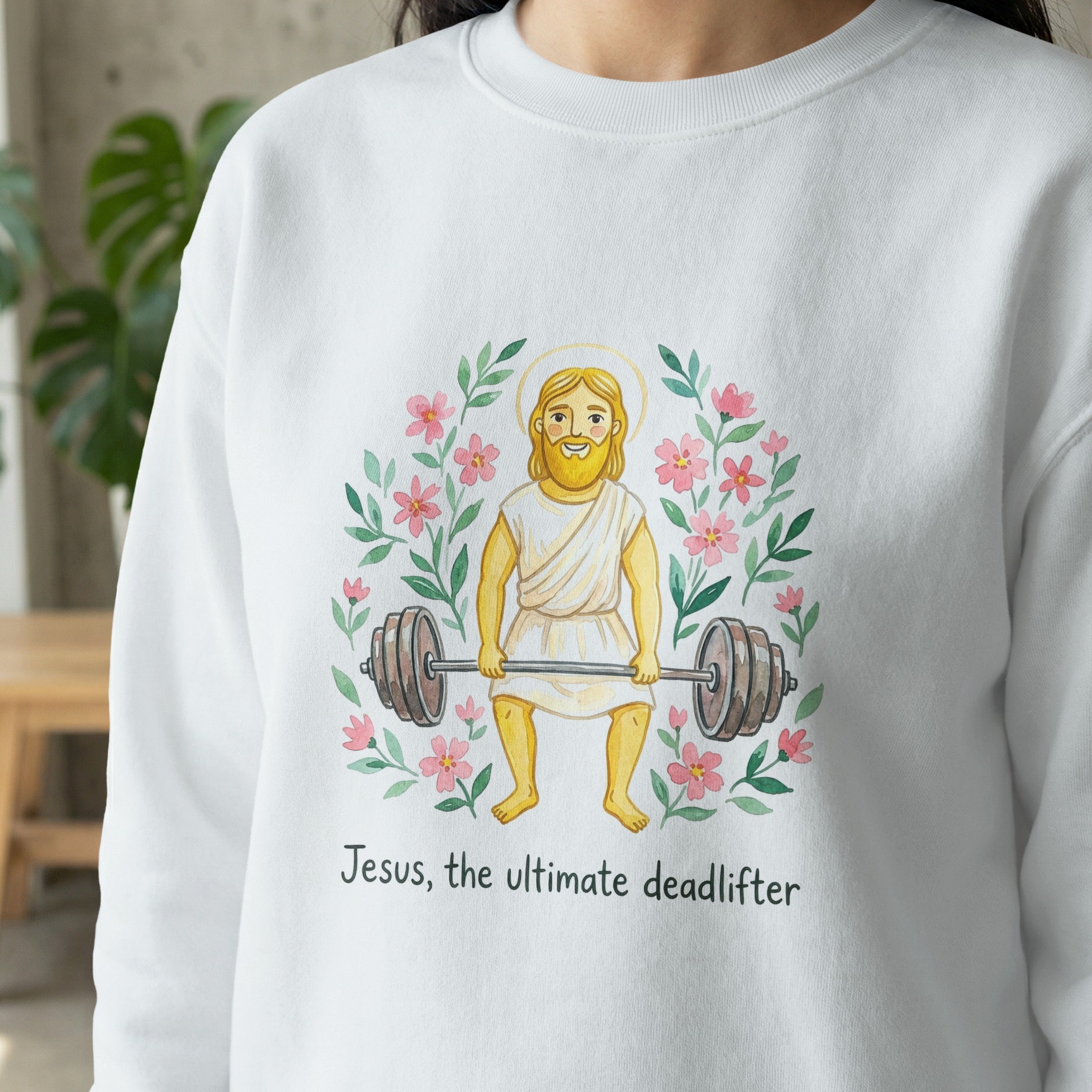 Jesus the ultimate deadlifter graphic on a white sweatshirt with flowers.
