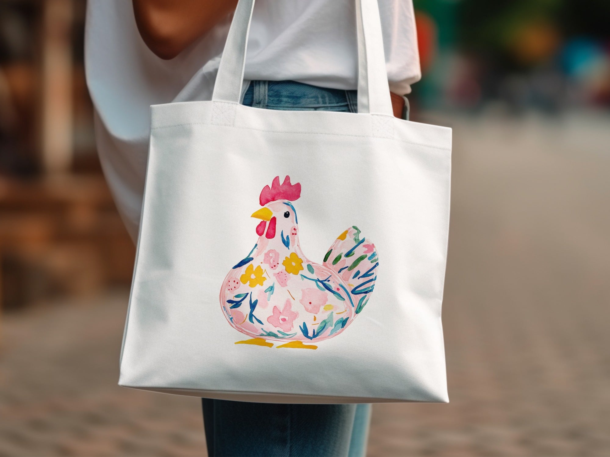 White tote bag with a colorful floral chicken illustration.
