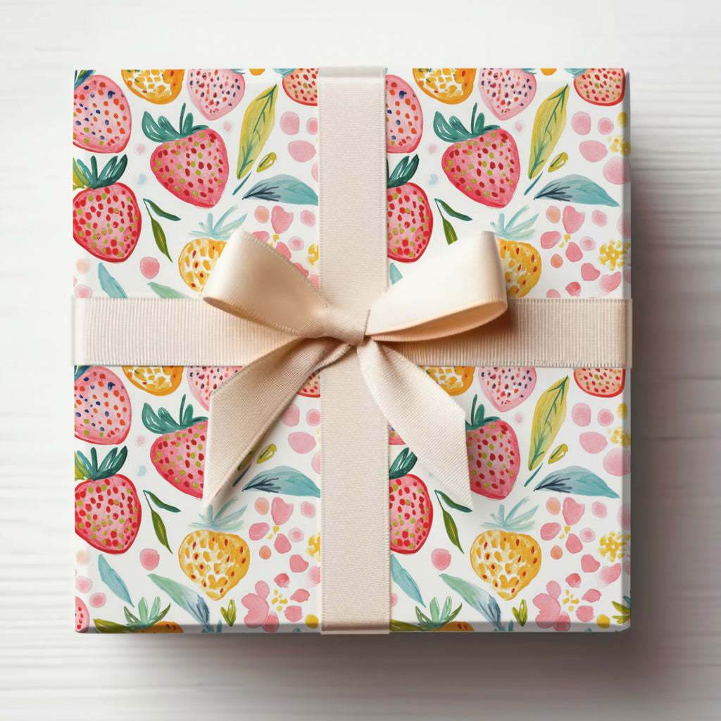 Gift-wrapped box with watercolor strawberry pattern and beige ribbon.