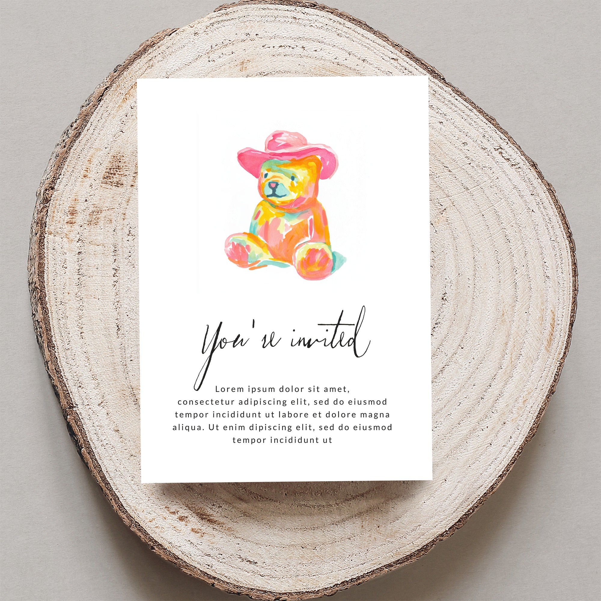 Watercolor teddy bear in pink hat on invitation with "You're invited" text.