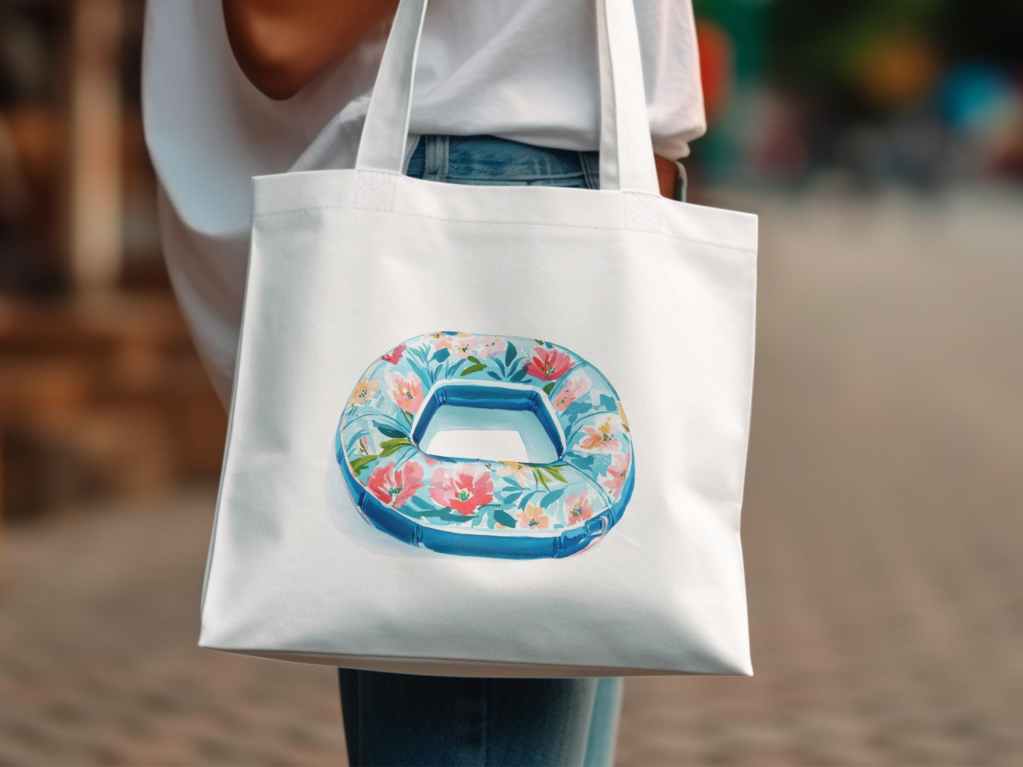 White tote bag with floral print inner tube graphic.