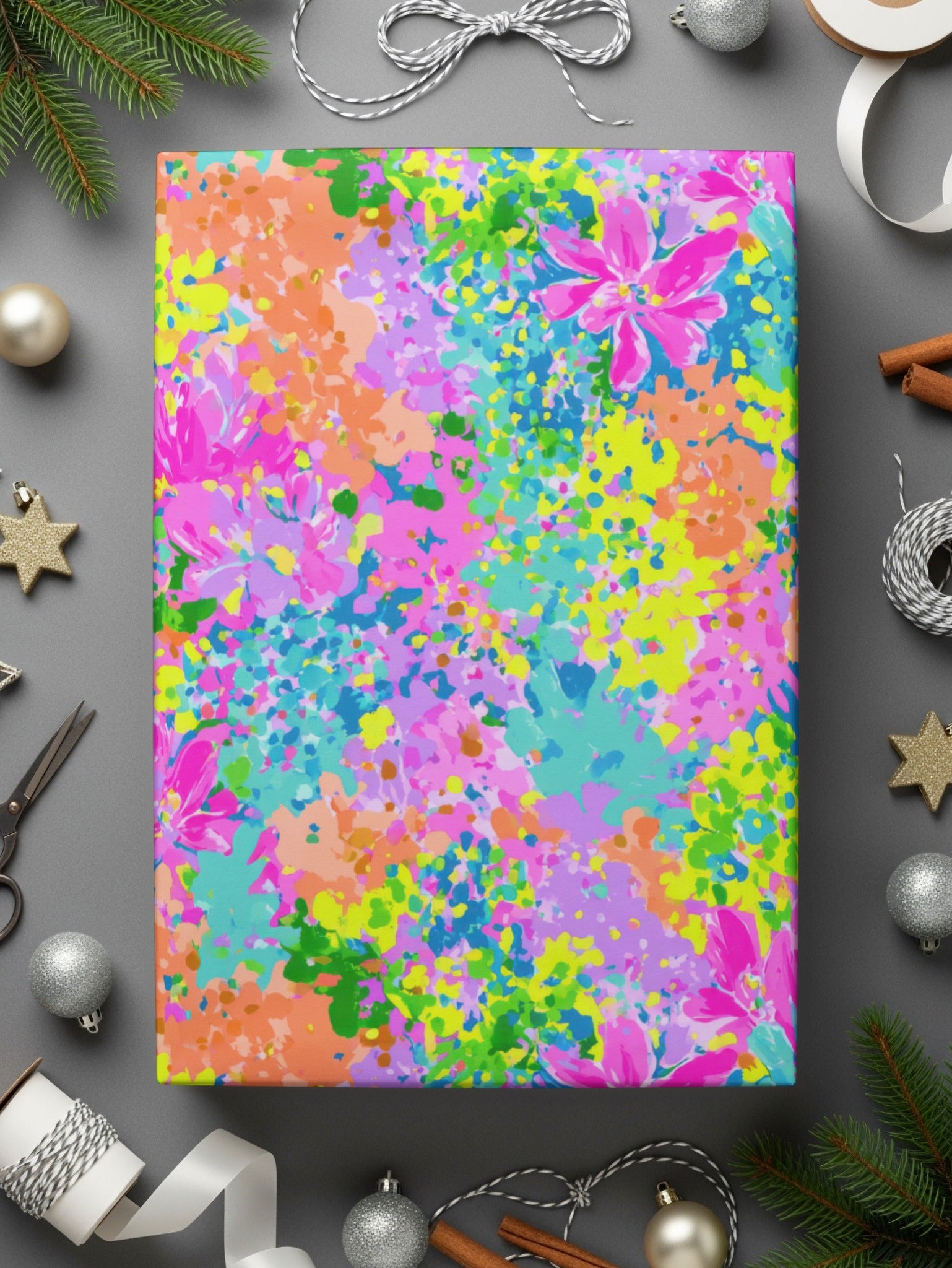Colorful floral pattern wrapping paper with scattered metallic star ornaments and ribbon.