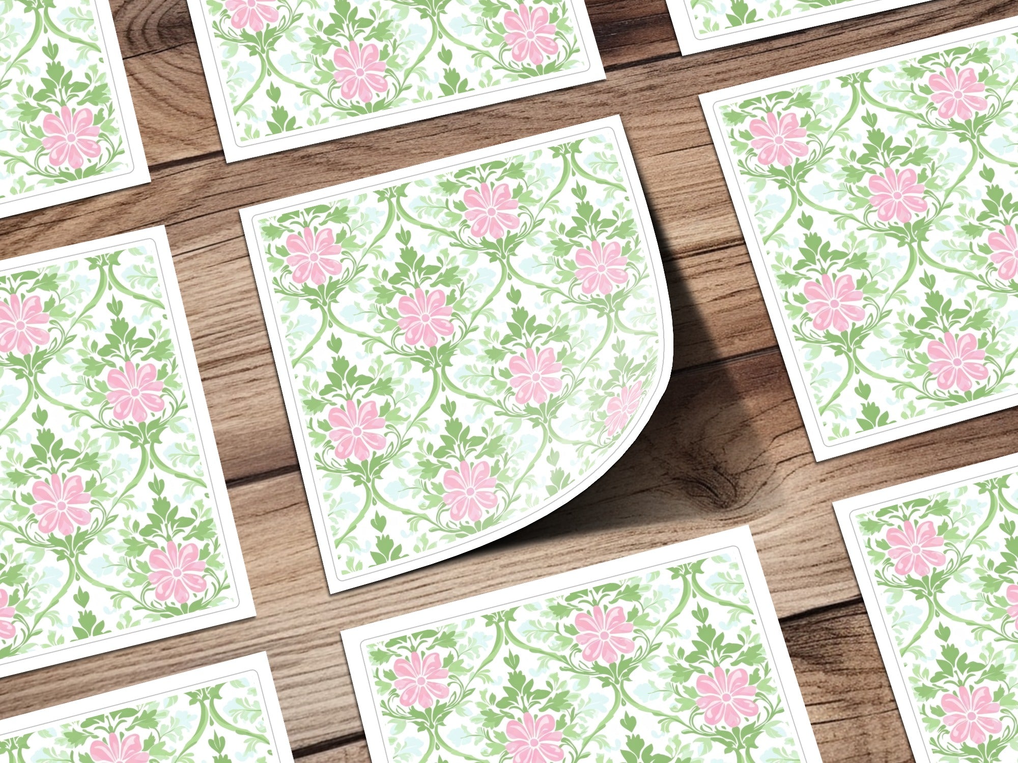 Floral pattern with pink flowers and green leaves on white cards.