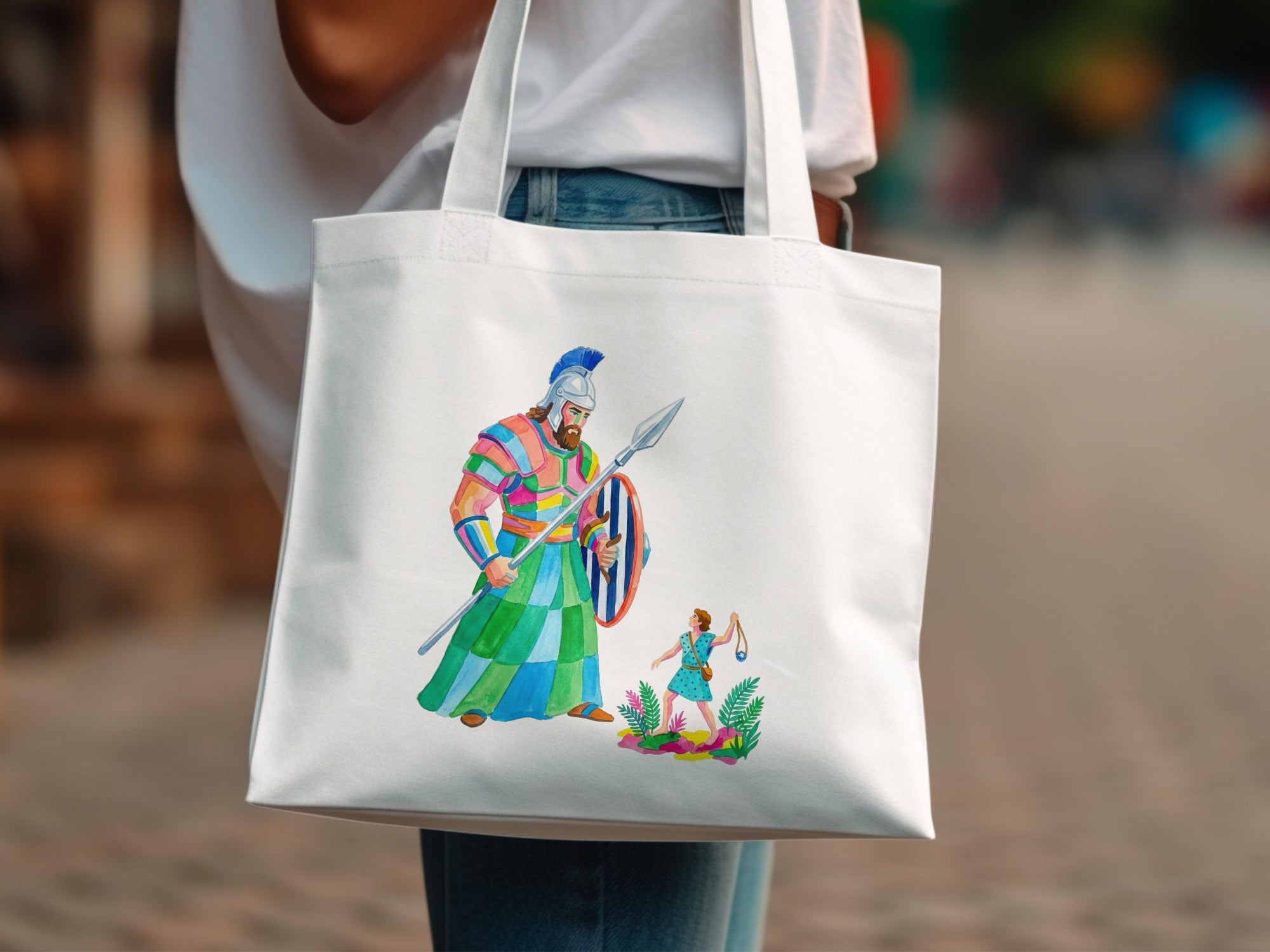 Tote bag with colorful illustration of a large warrior facing a small figure.
