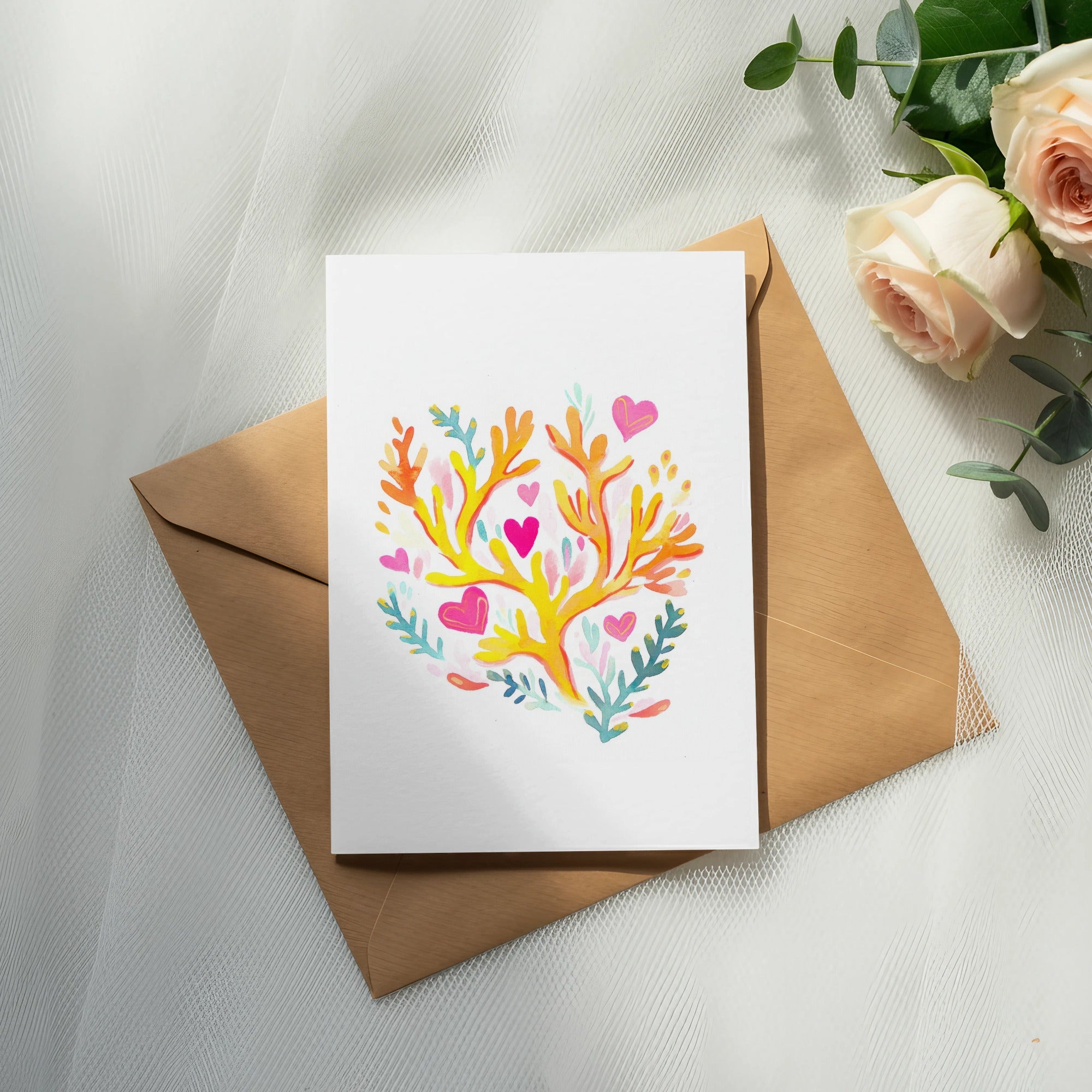 Card with colorful coral and heart design on brown envelope with roses.