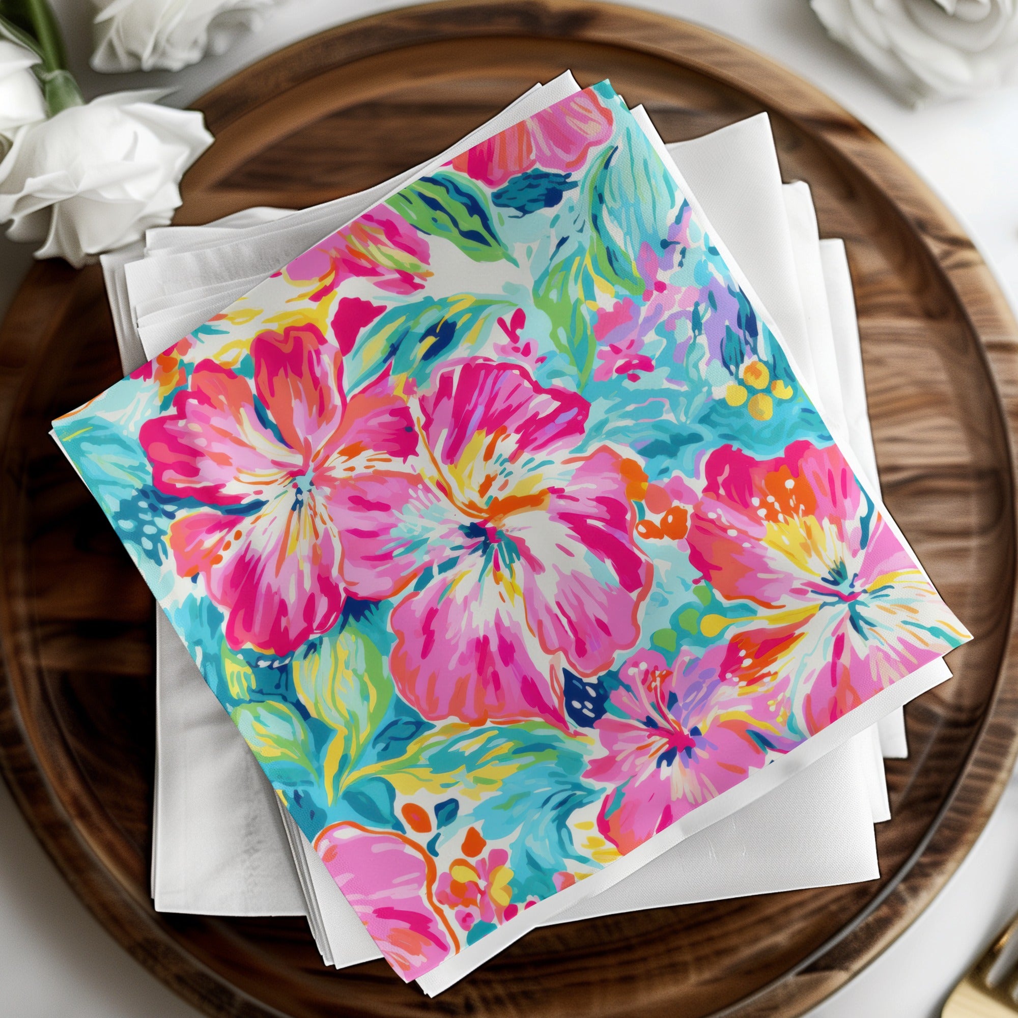 Colorful floral napkins on a wooden tray with white roses.