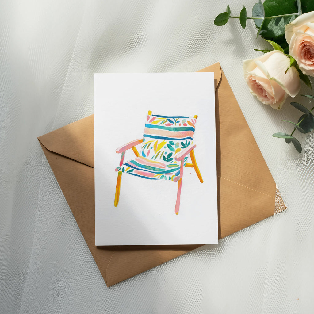 Watercolor illustration of a striped beach chair on a brown envelope with roses.