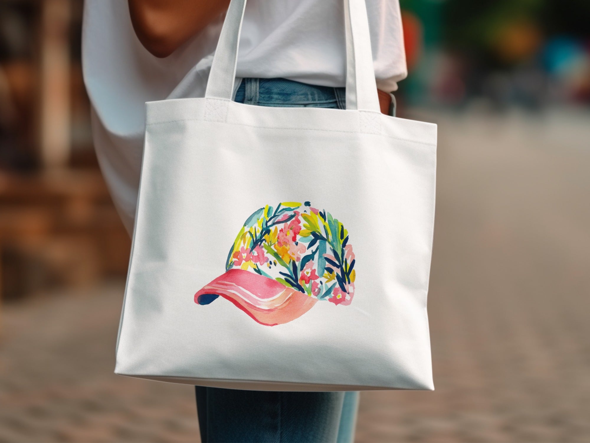 White tote bag with a watercolor floral baseball cap design.
