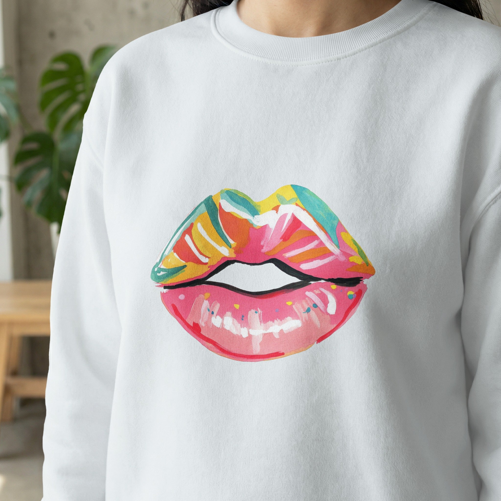 White sweatshirt with a colorful painted lips design.